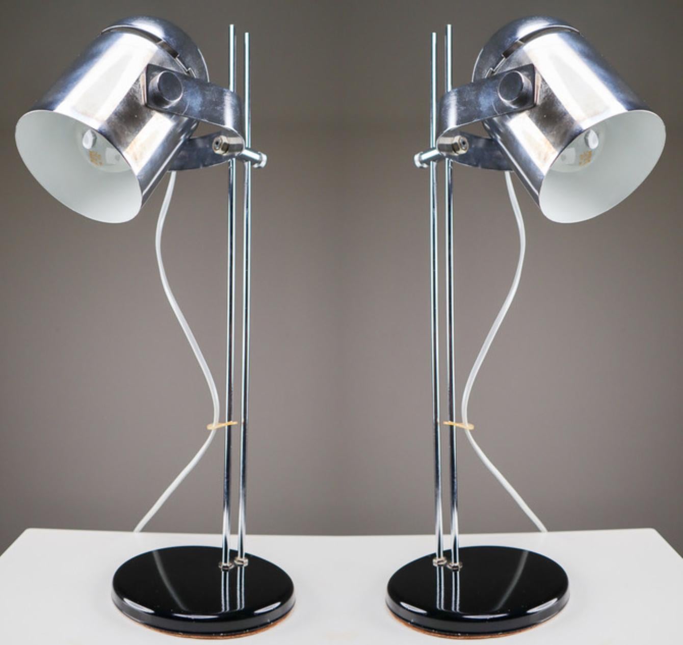 A large set of sixteen German adjustable height desk lamps, with cylindrical polish steel shade on a chromed metal post with circular black metal base. The shade can be moved up and down the post to the desired height and the shade can be easily