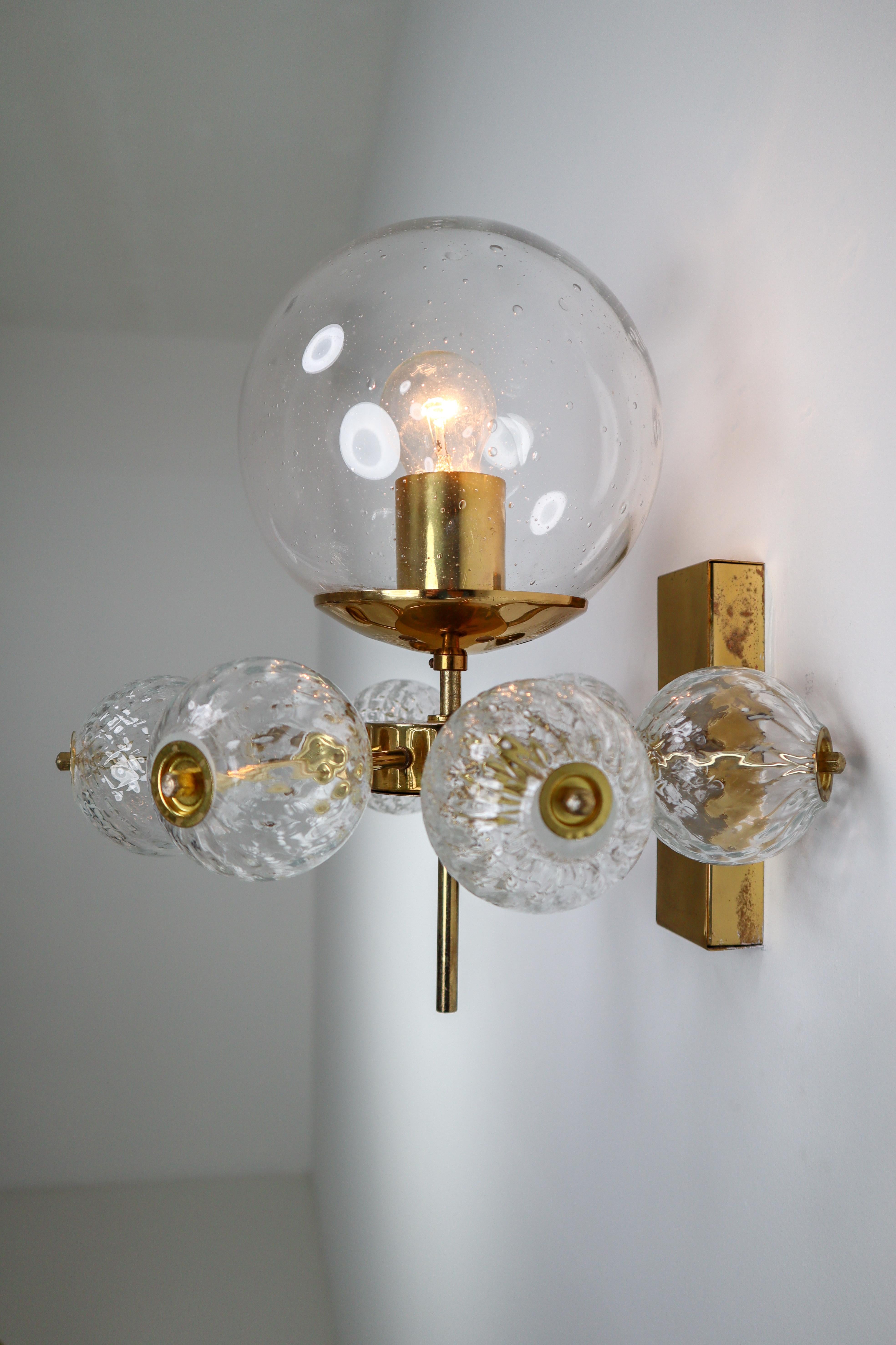 Large set of 20 hotel wall chandeliers with brass fixture and large hand blown glass. The scones are beautifully decorated thanks to the structured glass. The pleasant light it spreads is very atmospheric, these wall chandeliers will contribute to a