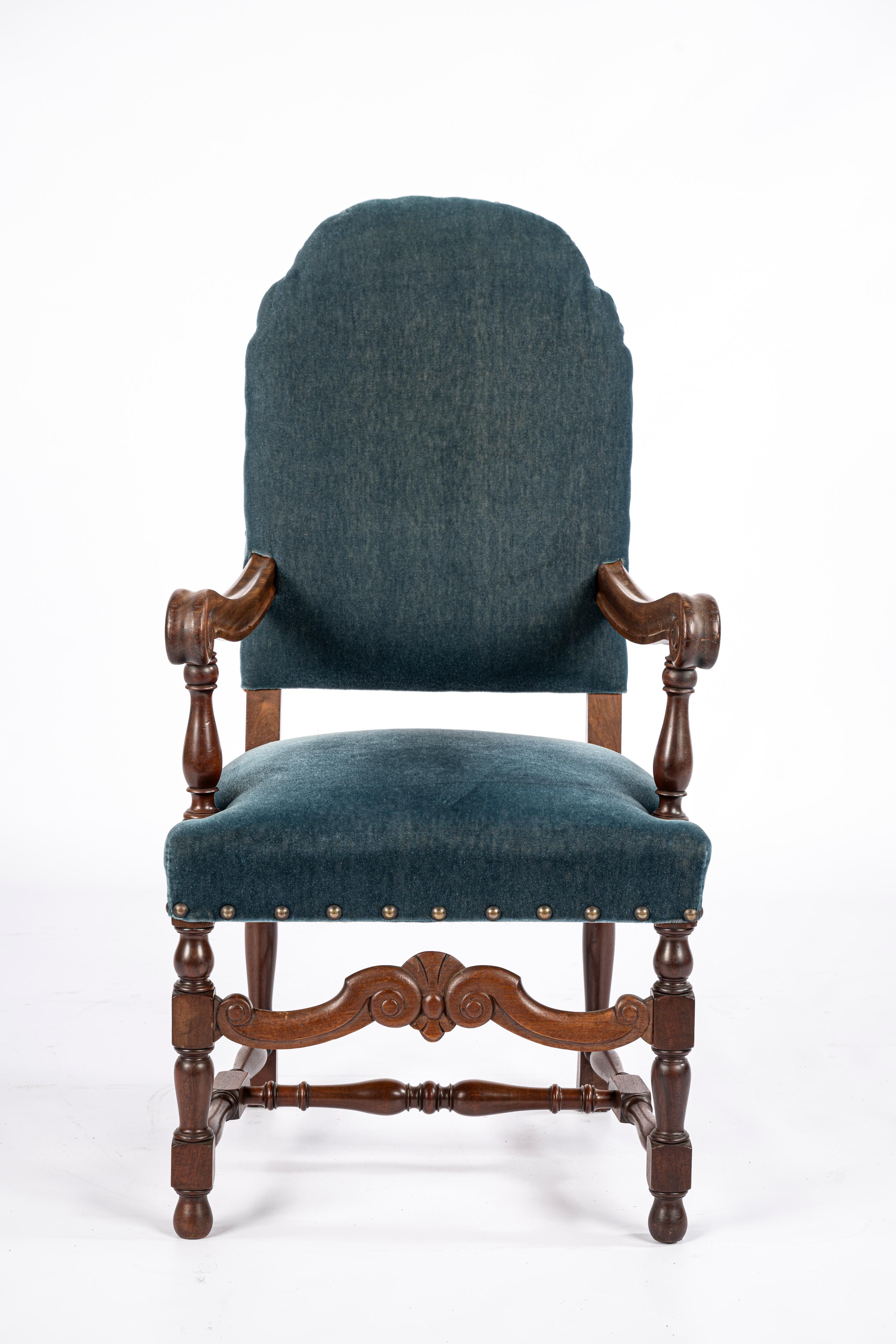 On offer here is a beautifully crafted set of 10 armchairs made in France around the mid-20th century, circa 1950. These chairs feature solid walnut frames with turned legs and hand-carved details. They retain their original upholstery—a