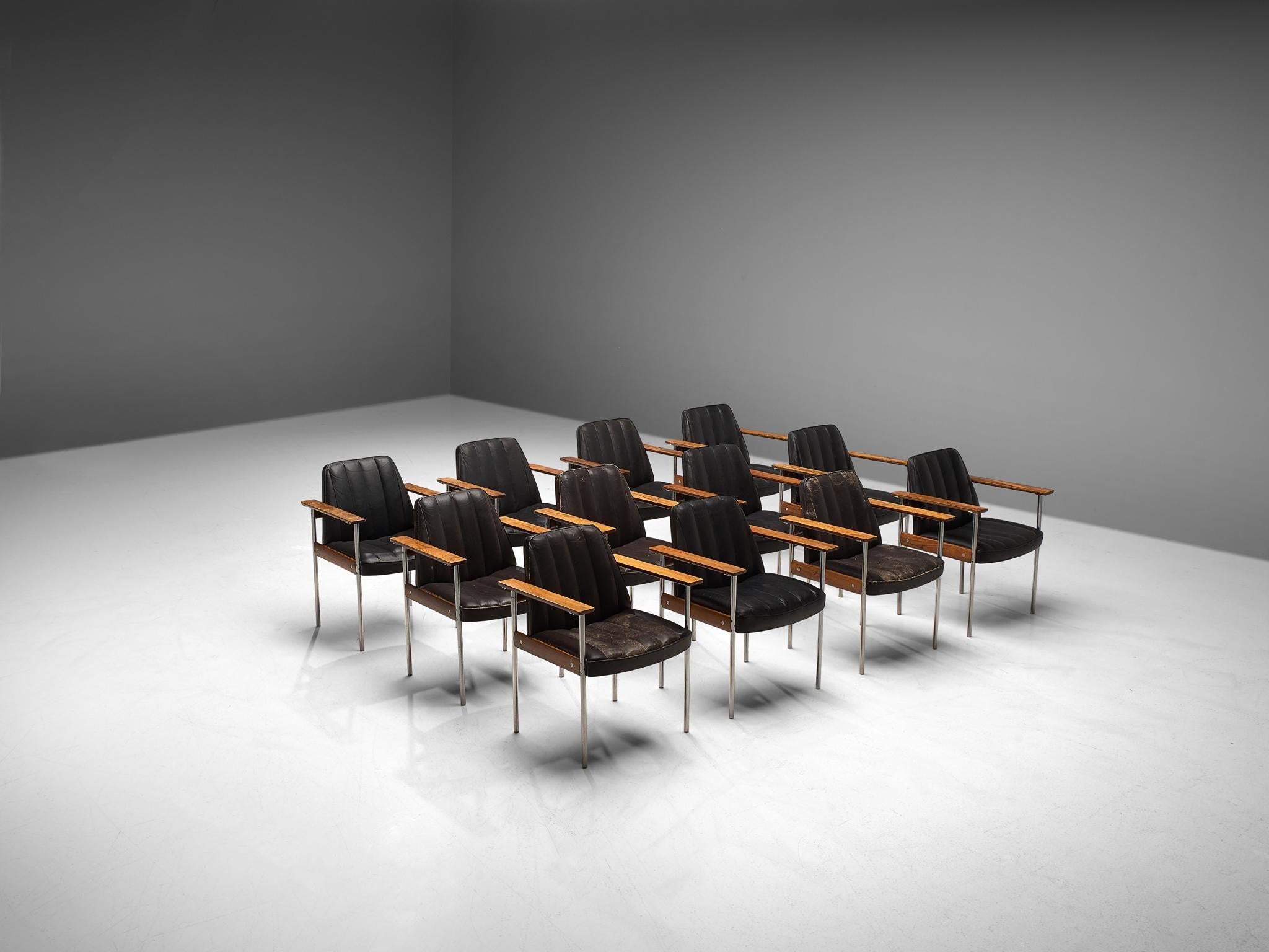 Sven Ivar Dysthe for Dokke Møbler, combined set of 24 dining chairs, black leather, steel, rosewood, Norway, circa 1959. 

These well-crafted office chairs are designed by Sven Ivar Dysthe. The base of these office chairs is made of rosewood with