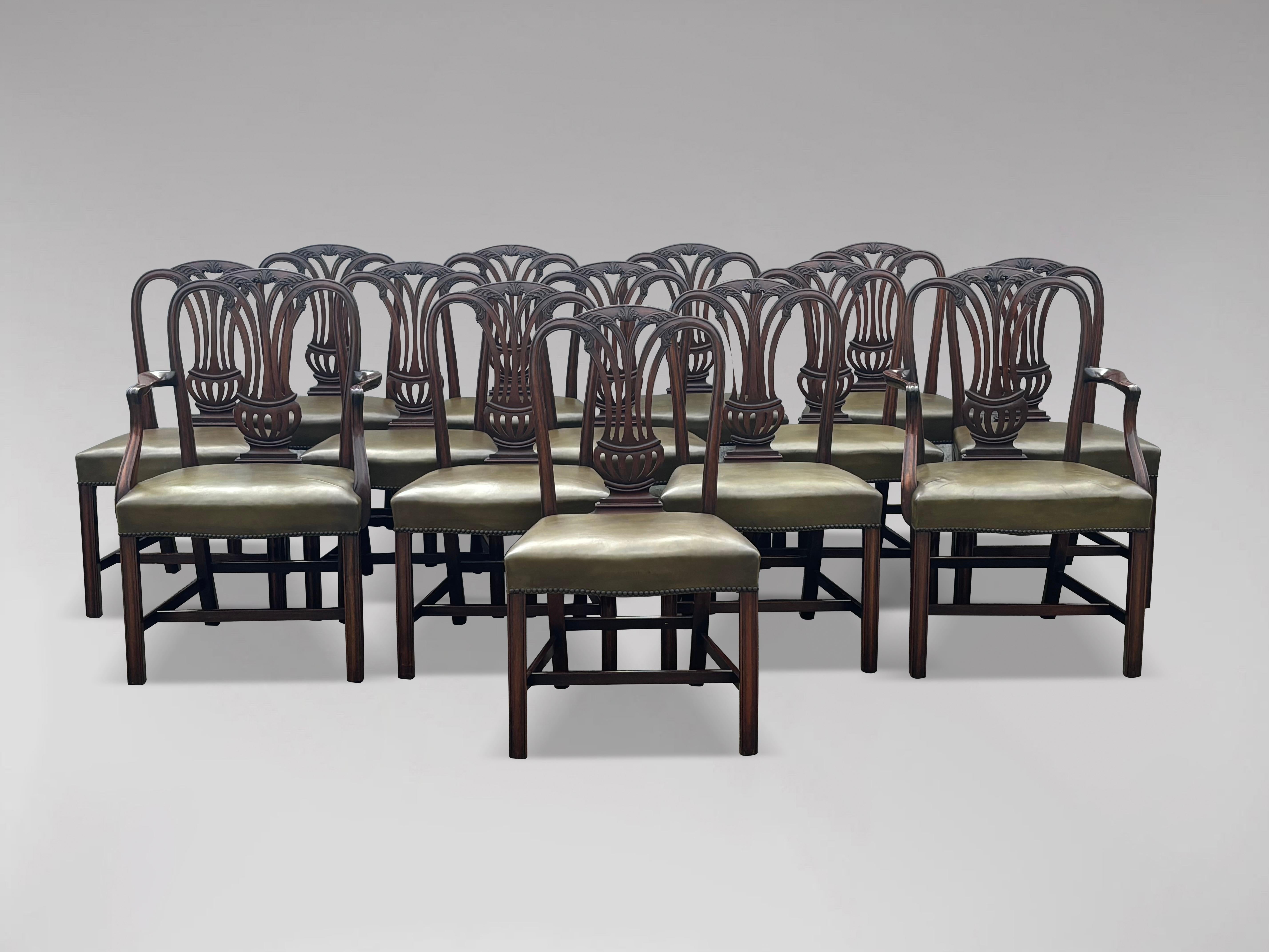 A quality large set of 14 Georgian Hepplewhite style mahogany dining chairs of good colour and condition with broad reupholstered leather seats, generously wide in profile, affording comfortable seating. This large set of 2 armchairs and 12 dining