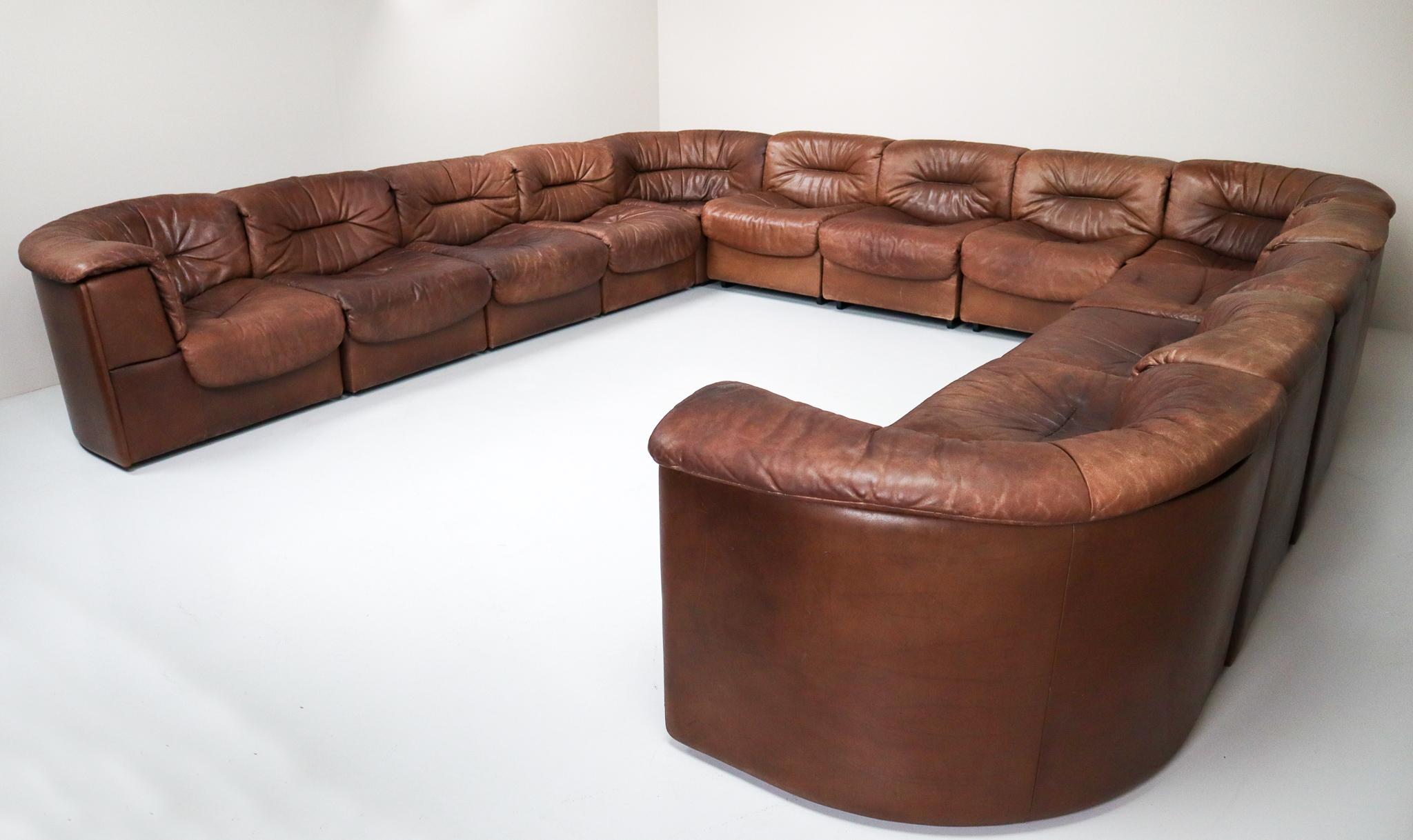 Large set of 19 elements patinated leather De Sede DS 14 modular sofa, 1970.
This comfortable leather sofa is manufactured by De Sede in Switzerland. Sectional sofa by the Swiss quality manufacturer De Sede. This large sofa exists of 19 elements, 6