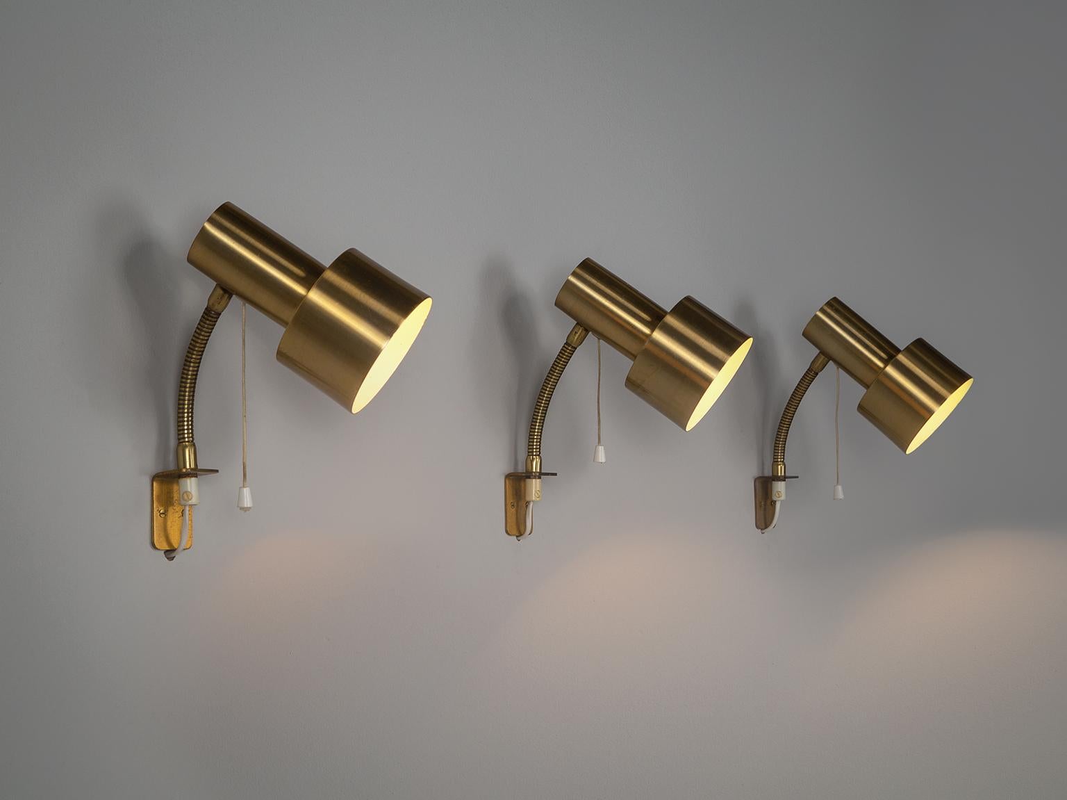 Large set of Swedish wall lamps with brass shades and adjustable stem, so both the wall and the surrounding room can be illuminated. 

Please note the price is per item.

