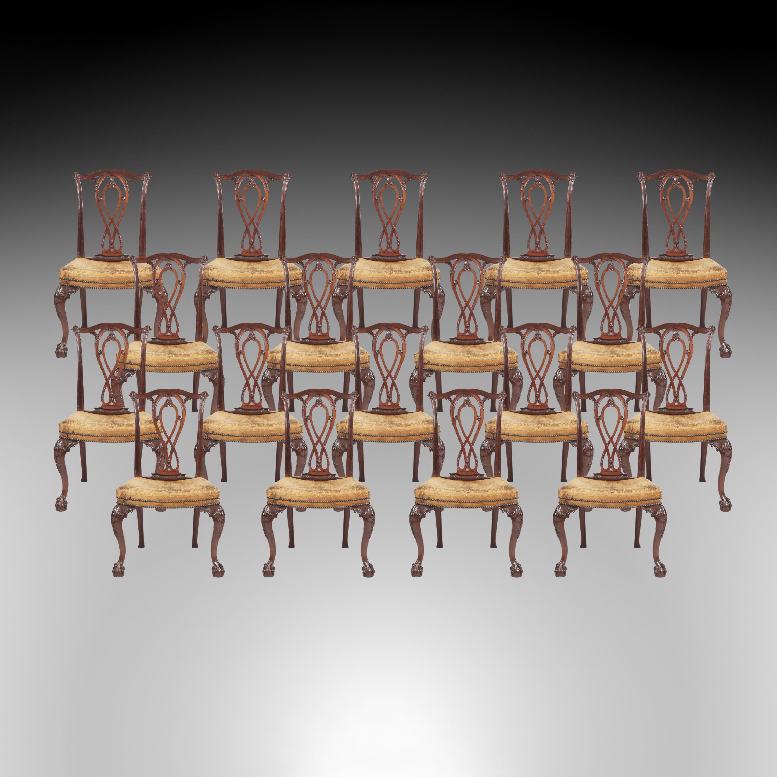 A Long Set of Eighteen Dining Chairs in the Early Georgian Manner

Constructed in mahogany, after a design by Robert Manwaring; rising from ball and claw cabriole legs, with foliate carved ears, with kick away legs to the rear; the dished seats