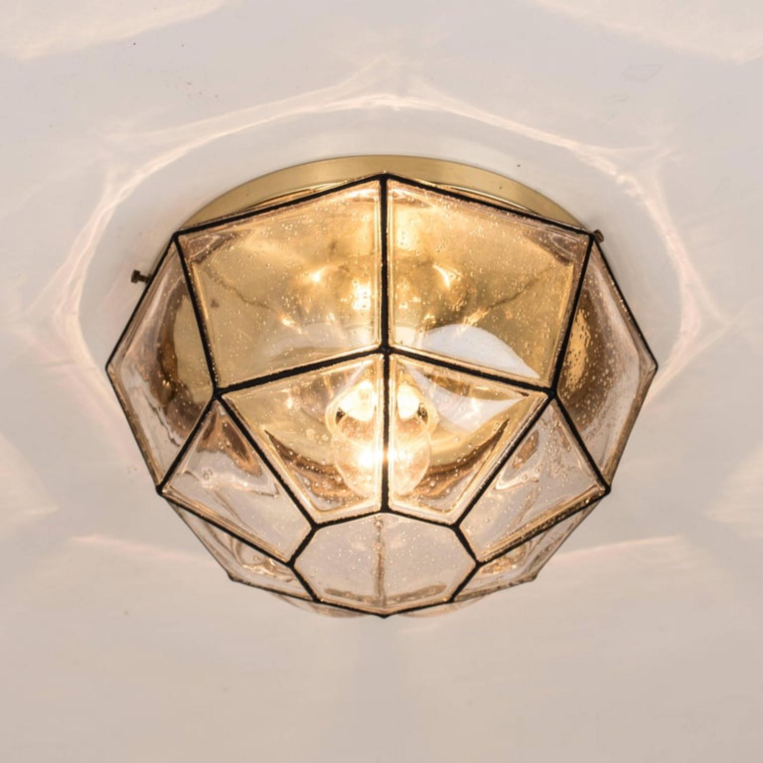 This beautiful and unique octagonal set of glass light flush mounts or wall lights were manufactured by Glashütte Limburg in Germany during the 1960s (late 1960s or early 1970s). Nice craftsmanship. Elaborate clear bubble glass which bulges slightly