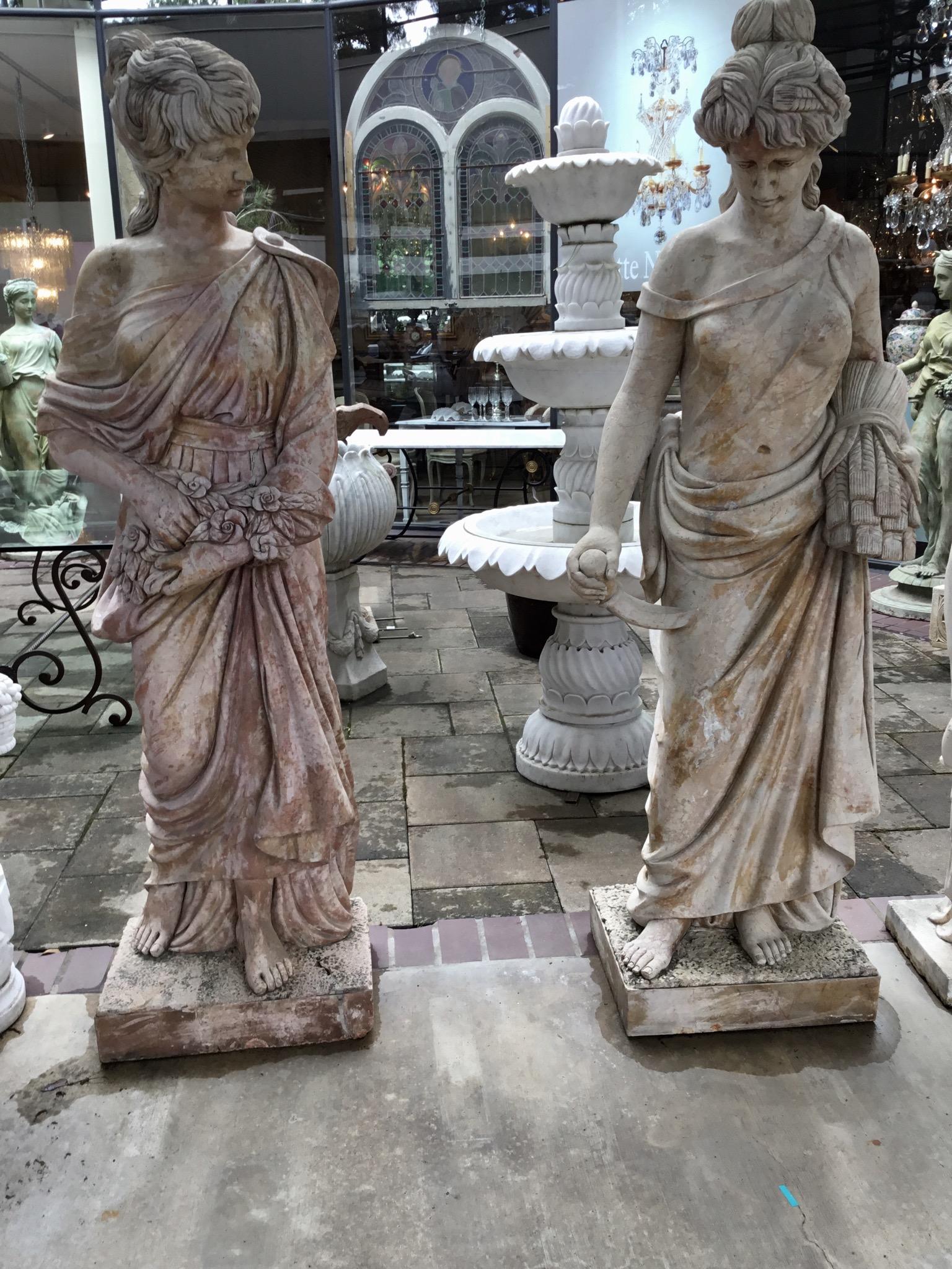 Vintage set of four large marble statues that have been hand carved in
Sienna marble after the original set at the Trevi fountain in Rome. Each
Statue represents a different season and each of the statues hold items that represent the seasons. The