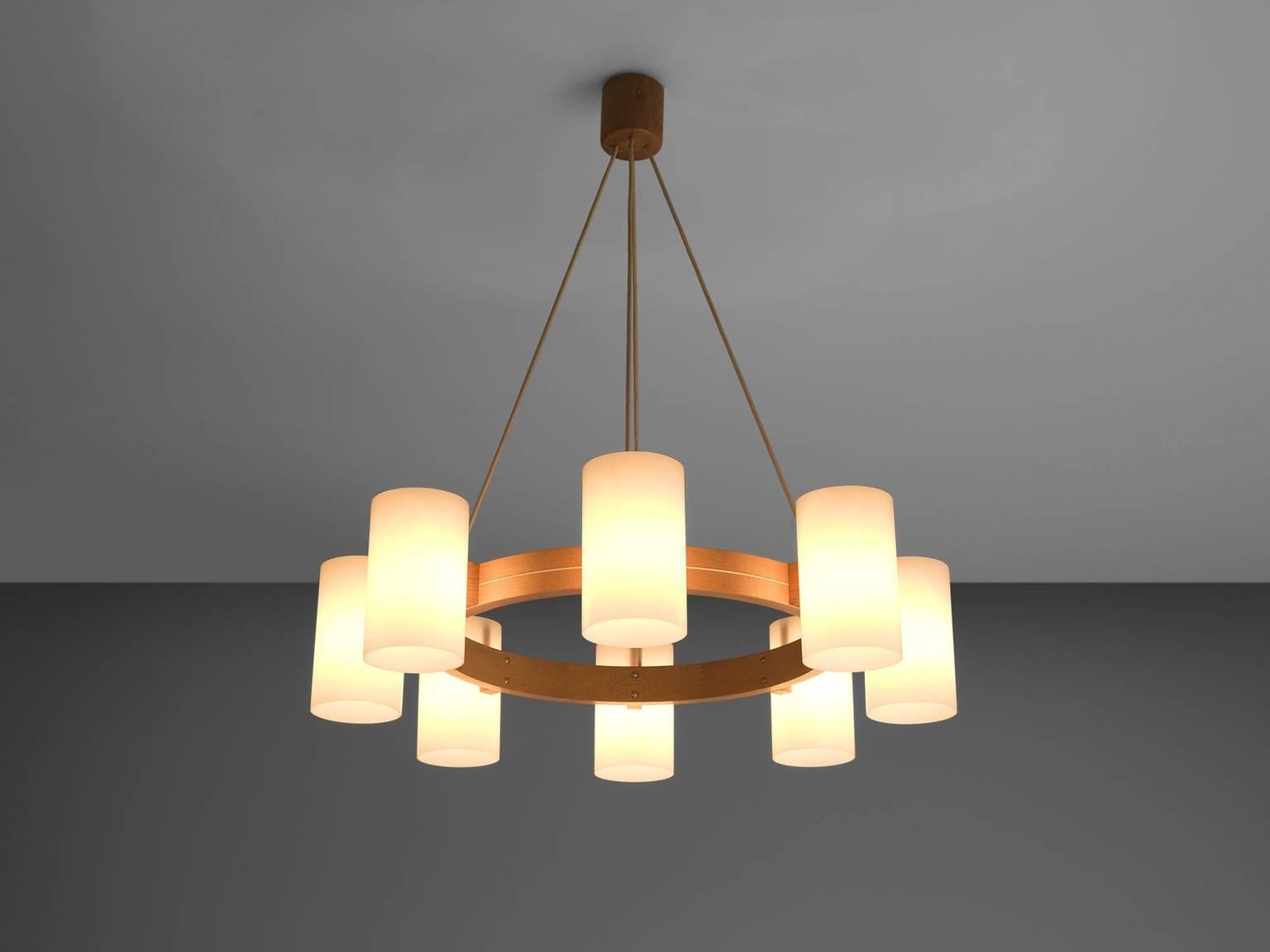 Chanderliers, oak and opaline white Lucite, Sweden, 1960s.

This is a large set of warm, soft and organic chandeliers by Luxus. These large sculptural wooden chandeliers with eight white spheres create a warm and soft environment. The wood is