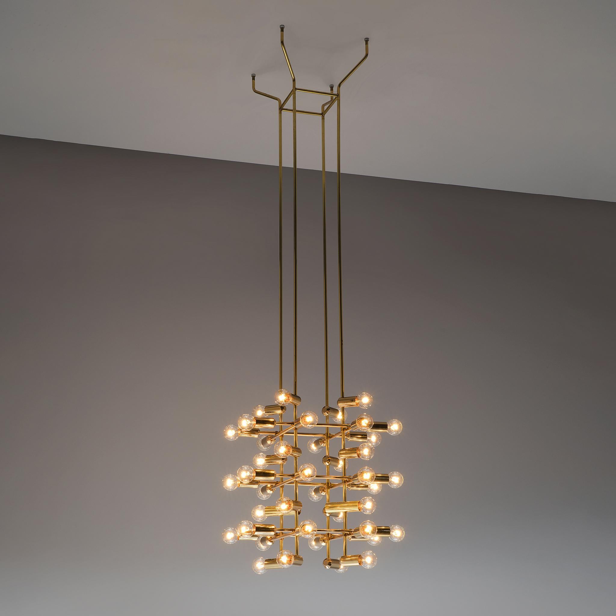 Chandelier, brass, Switzerland, 1960s 

This large chandelier from Swiss origin is beautifully sculpted concealing 40 lightbulbs that are attached on the ends of the brass horizontal beam. A lovely composition is created by means of the cross-like