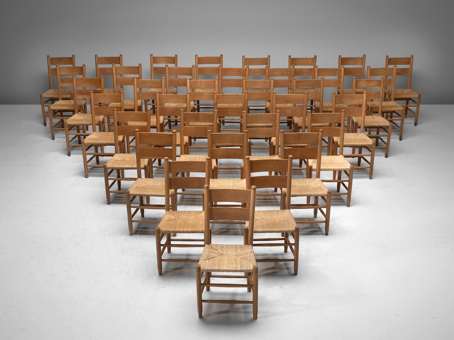 Large set of 36 church chairs, oak and rope, Denmark, 1960s.

Large set of Danish church chairs made in oak and with a rope woven seat. The chairs features subtle details, such as the double back rest and double slats below the seat. Please note