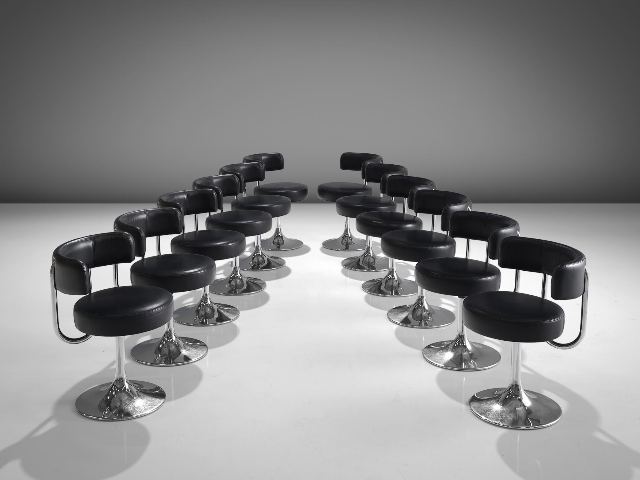 Börje Johanson for Johanson Design, set of twelve swivel dining chairs, metal, black leatherette, Sweden, 1970s.

Highly comfortable dining chairs in black leatherette upholstery. Due to the soft seat and back, these chairs provide a very pleasant