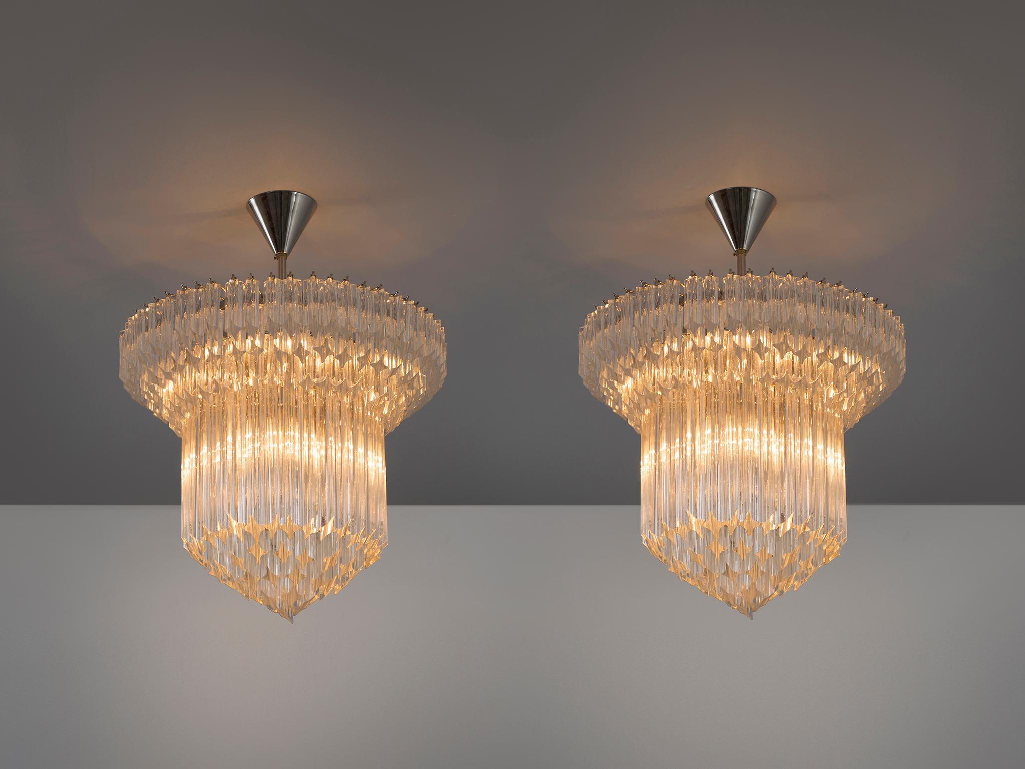 Venini, chandeliers, glass, polished nickel, Italy, 1970s.

Very elegant Venini chandeliers in glass and nickel. These high quality original 1970s productions still show the excellent quality they have been made with during that time. Coming from