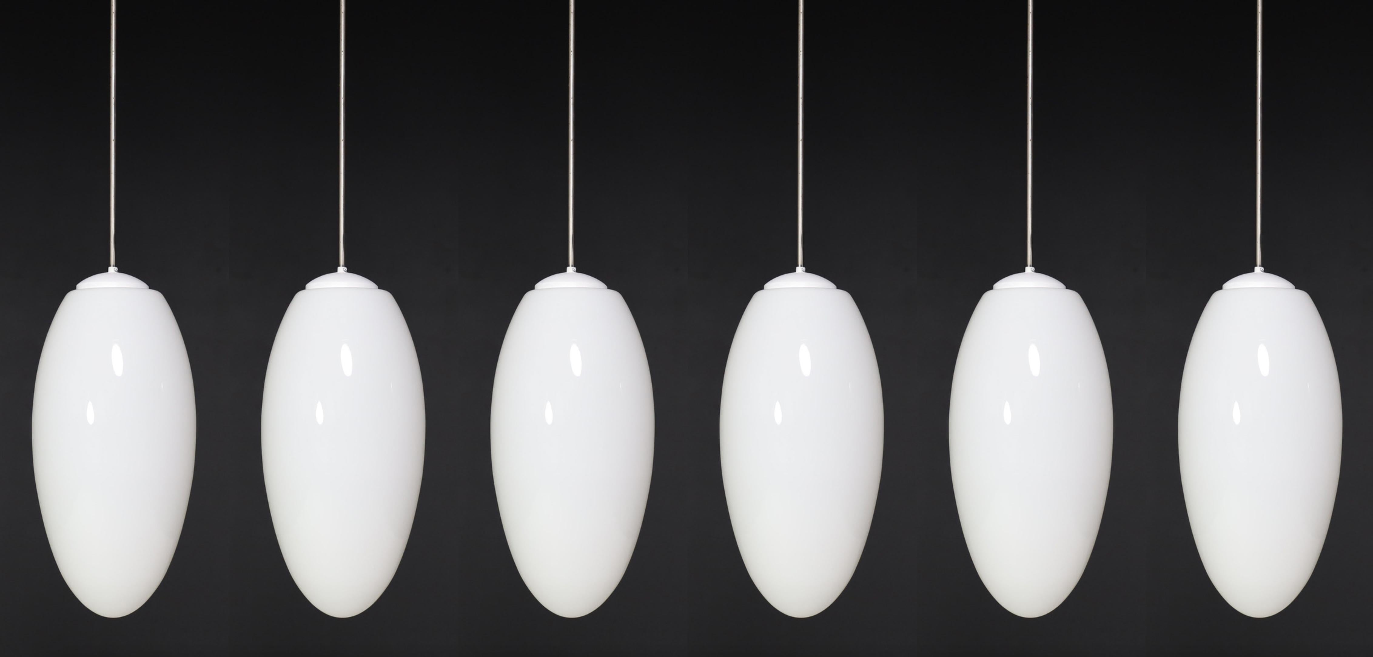 Large set pendants, ellipse opaline glass, Europe, the 1960s.

An extensive set of pendants, ellipse opaline glass, Europe, the 1960s. The diffuse light it spreads is very atmospheric. Completed with opaline glass and metal frame details, these