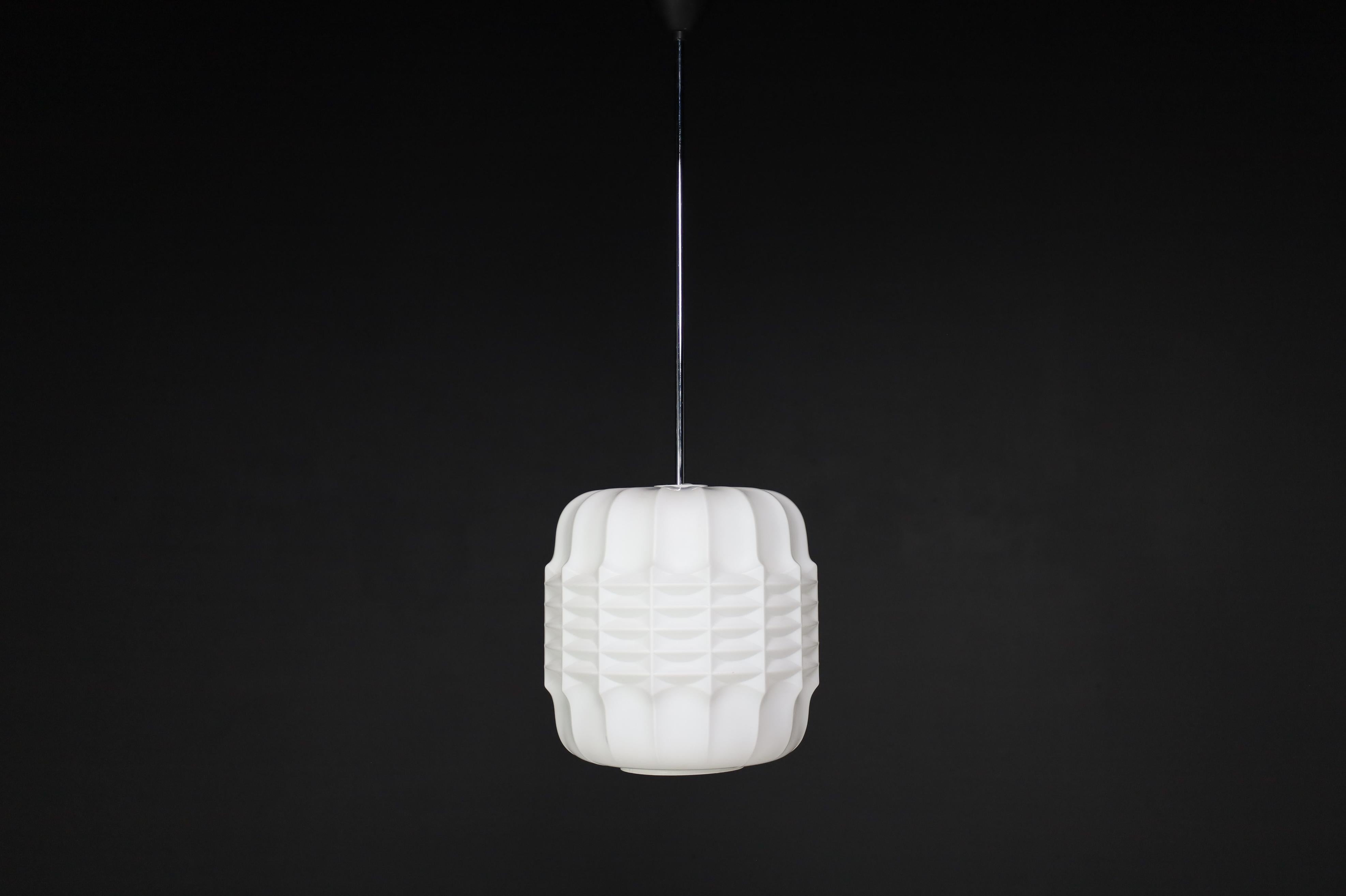 Brutalist Structured Opaline Glass Pendant, Europe 1960s

A large set of brutalist pendants, opaline glass, Europe, the 1960s. The diffuse light it spreads is very atmospheric. Completed with opaline glass and metal frame details, these pendants