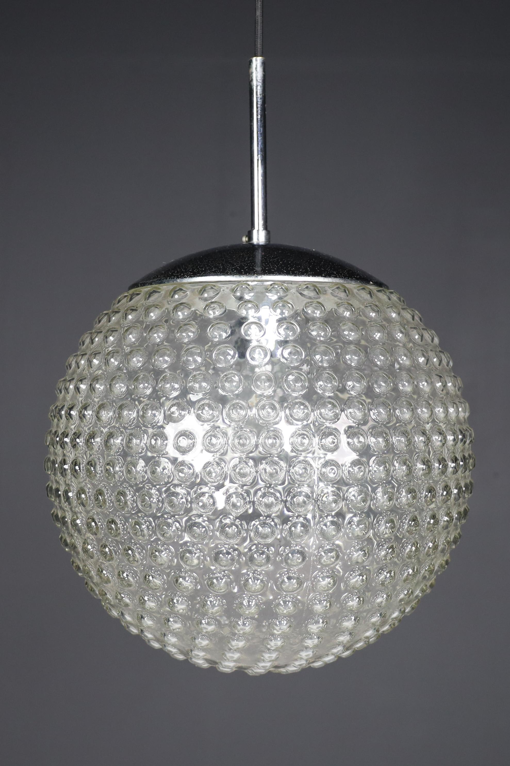 Rolf Krüger Bubble Glass Pendant for Staff, Germany 1970s

Rolf Krüger for Staff designed these beautiful bubble glass pendants in Germany during the 1970s. They come with chromed hardware and black cord wire, and the glass boasts a subtle bubble
