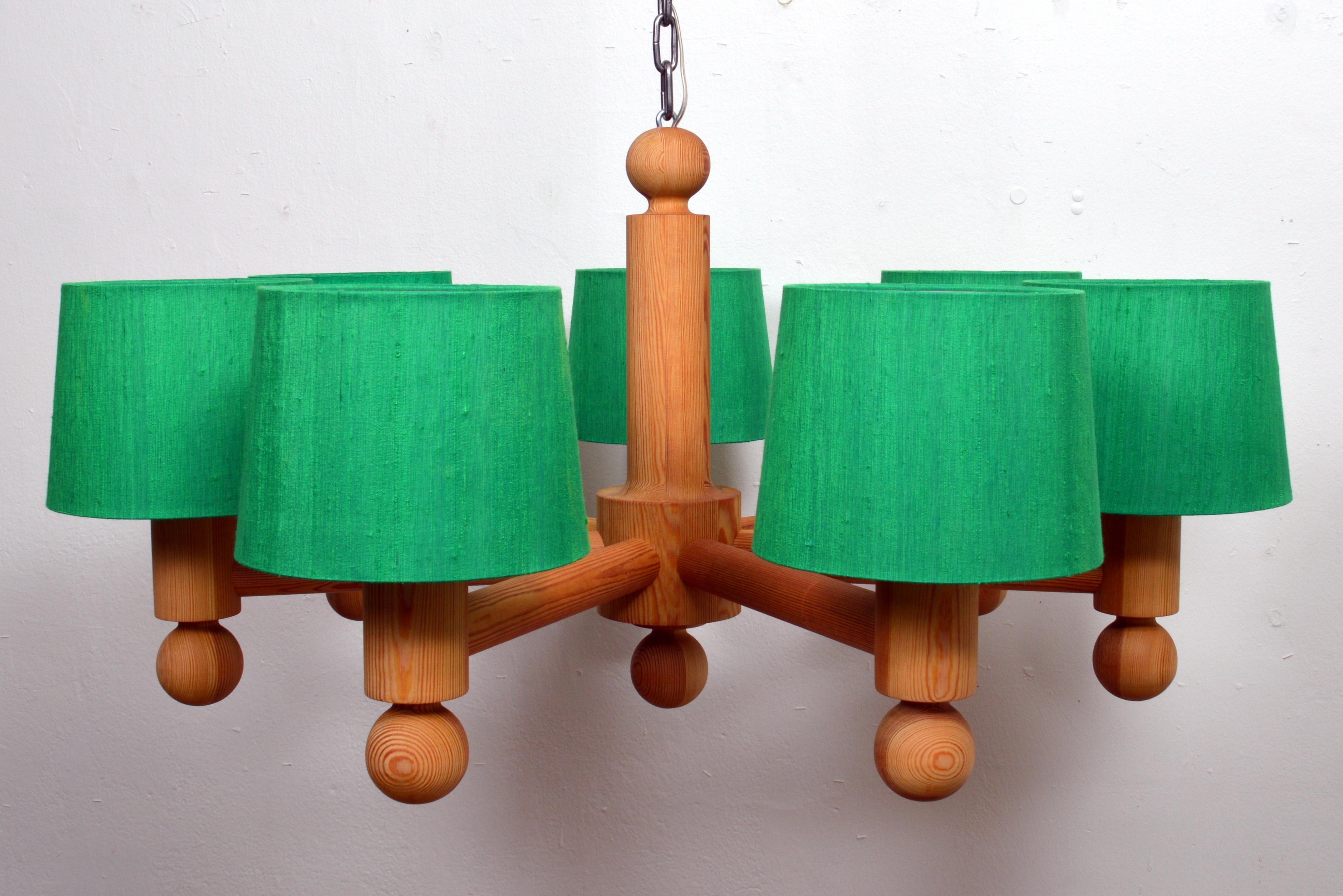 This unique, NOS; New Old Stock, never used solid pine wood, seven-light chandelier was created in this “golden age of Scandinavian design”, a period that saw the revival of an elementary, undecorated visual language, emphasizing sleek design and