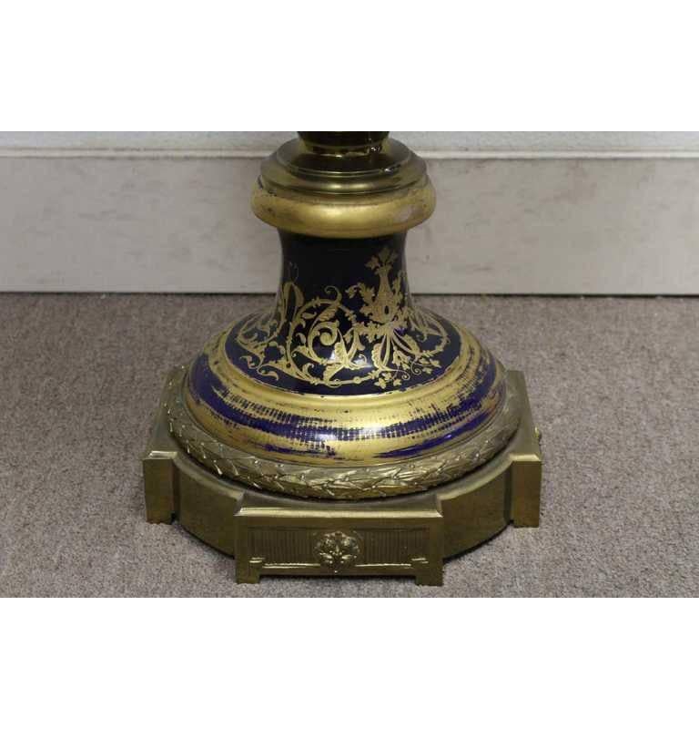 Attractive and large late 19th century French Sevres style hand-painted and gold traced cobalt blue covered urn signed A. Maglin with bronze base and finial. Depicting a finely painted battle scene all the way around.