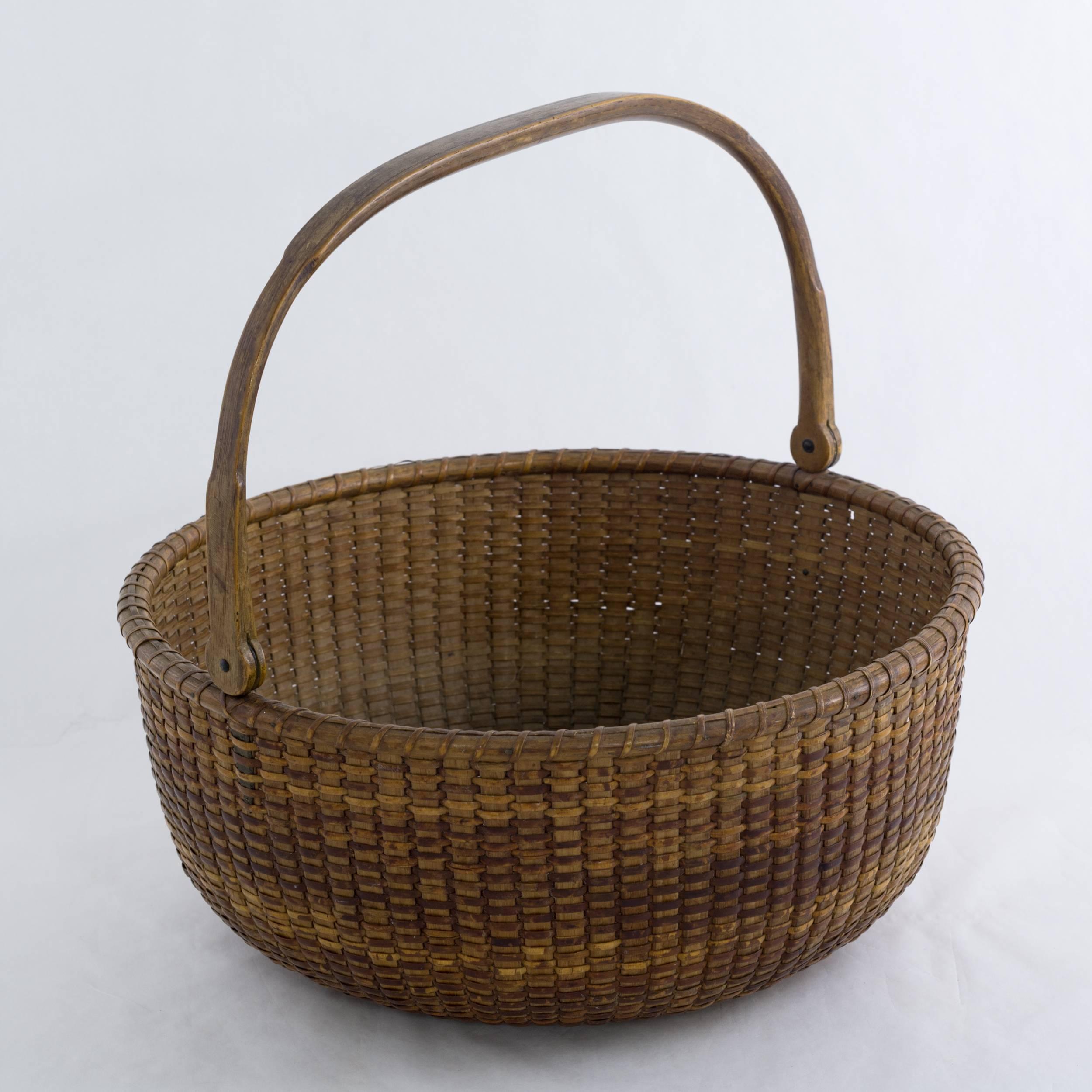 Made on board the South Shoal Lightship. Constructed with oak staves and swing handle and pine bottom. The carved and notched handle and the two incised circles on the inside bottom are typical trademarks of Hall's basket. Hall is considered one of
