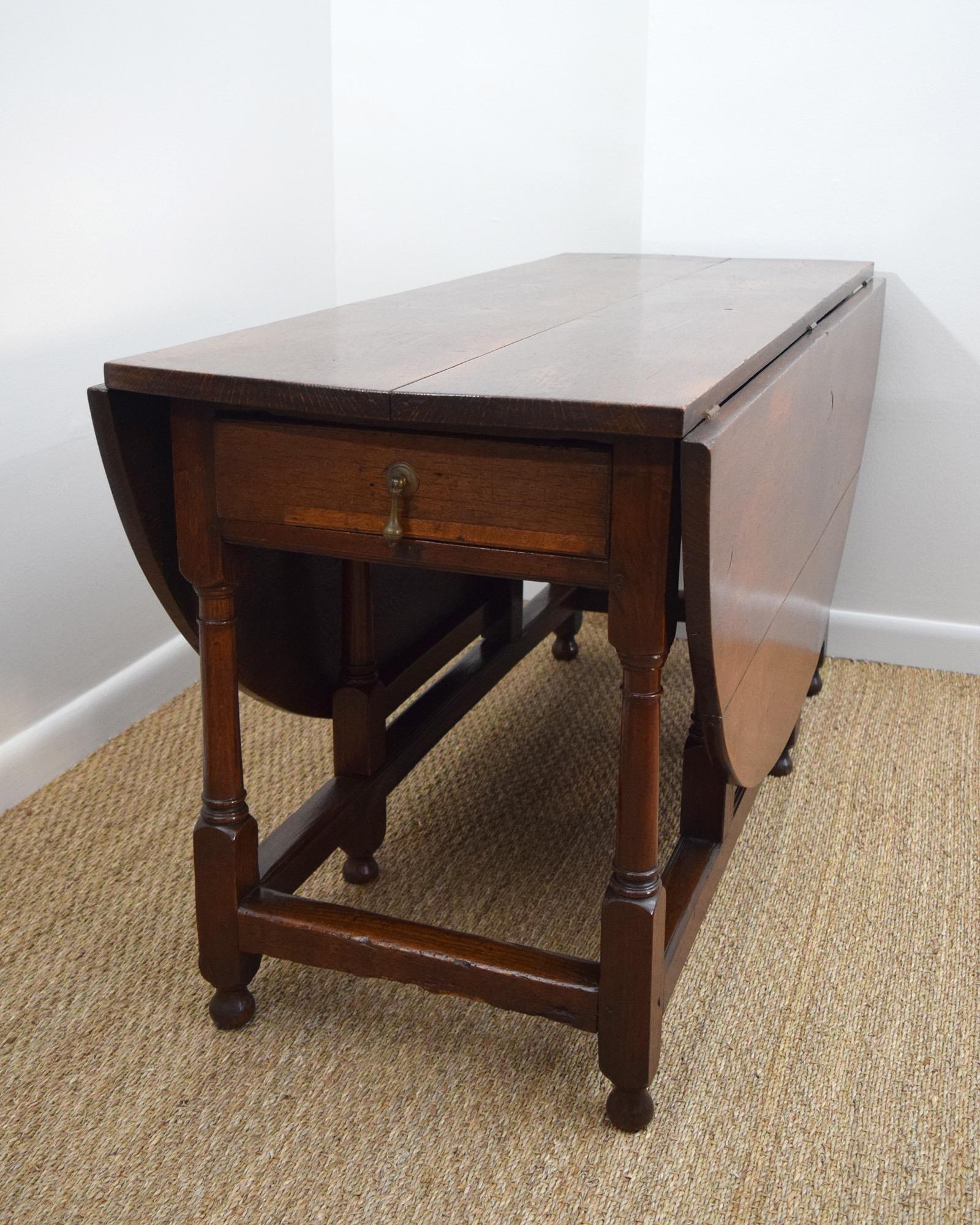 French gate-leg table, circa 1650. Oak with metal fittings. Measures: Height 28 ¼“ width 54“ depth 20 ½“ / 41 ½“/ 62“ $20,000.

This solid oak French Baroque table has two pivoting legs on each side to support hinged leaves. It can do triple duty