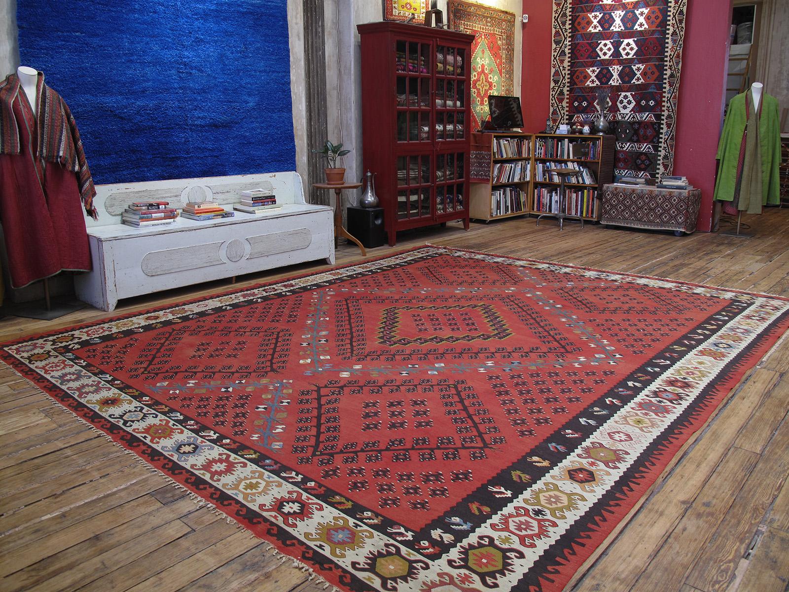 A large kilim from the Balkan peninsula in southeastern Europe. This is a great example from the early part of the 20th century, featuring one of the best-known designs of this type in a very attractive color palette.