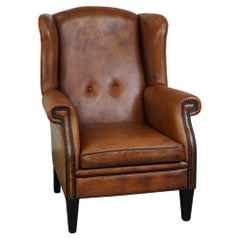 Large sheepskin leather wingback armchair in good condition, English style