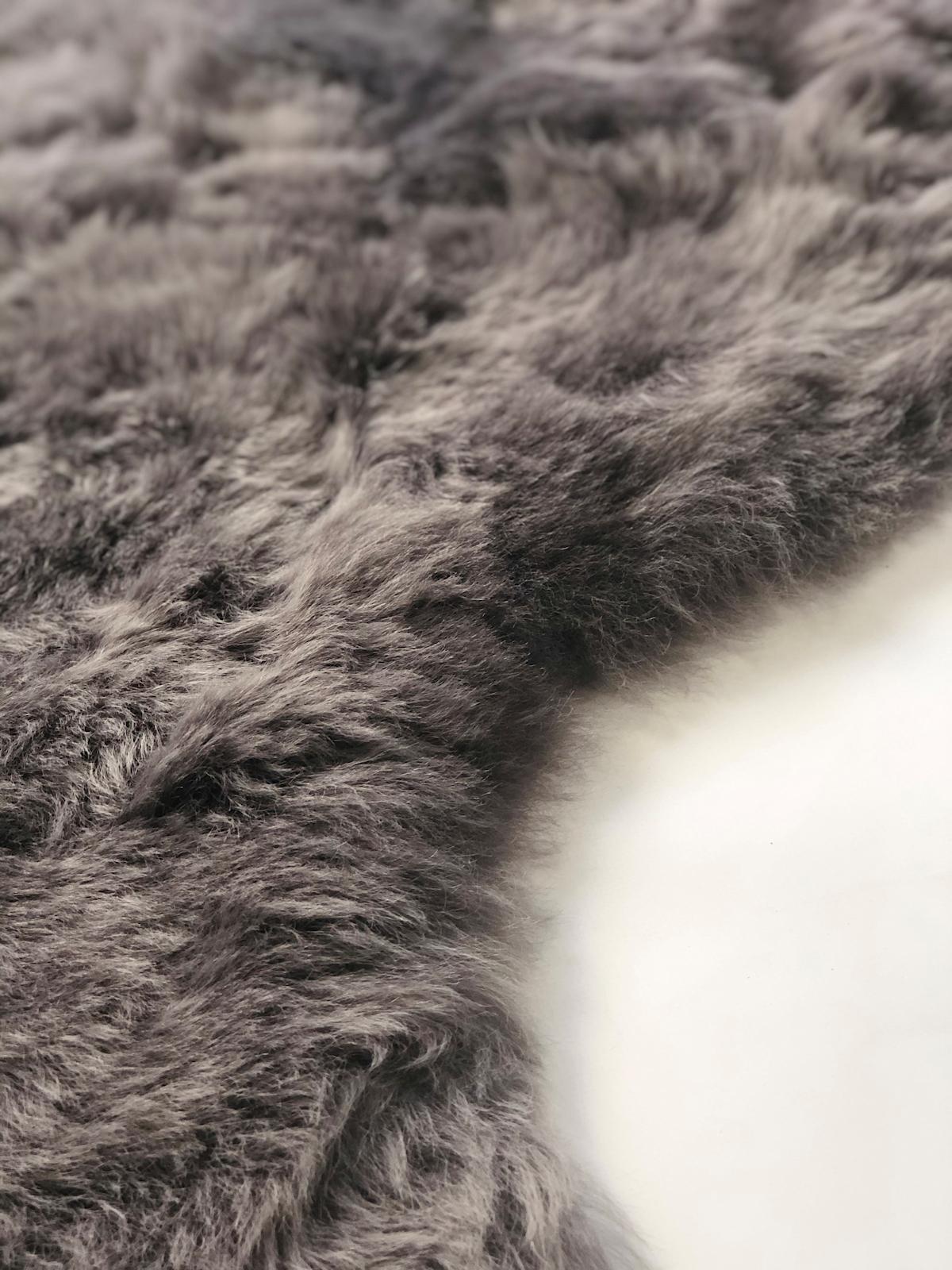 This large sheepskin throw rug will create an atmosphere of stylish design and luxurious comfort, handcrafted from the finest quality short wool Icelandic Sheepskin. This charming and endearing grey sheepskin throw rug expresses the beauty of