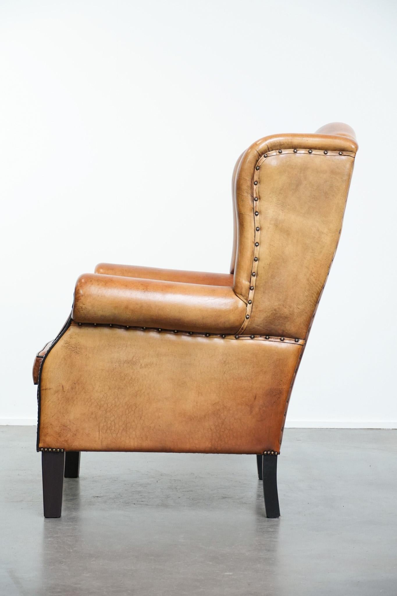 XXIe siècle et contemporain Grand fauteuil à oreilles en peau de mouton avec passepoil noir et clous décoratifs en vente