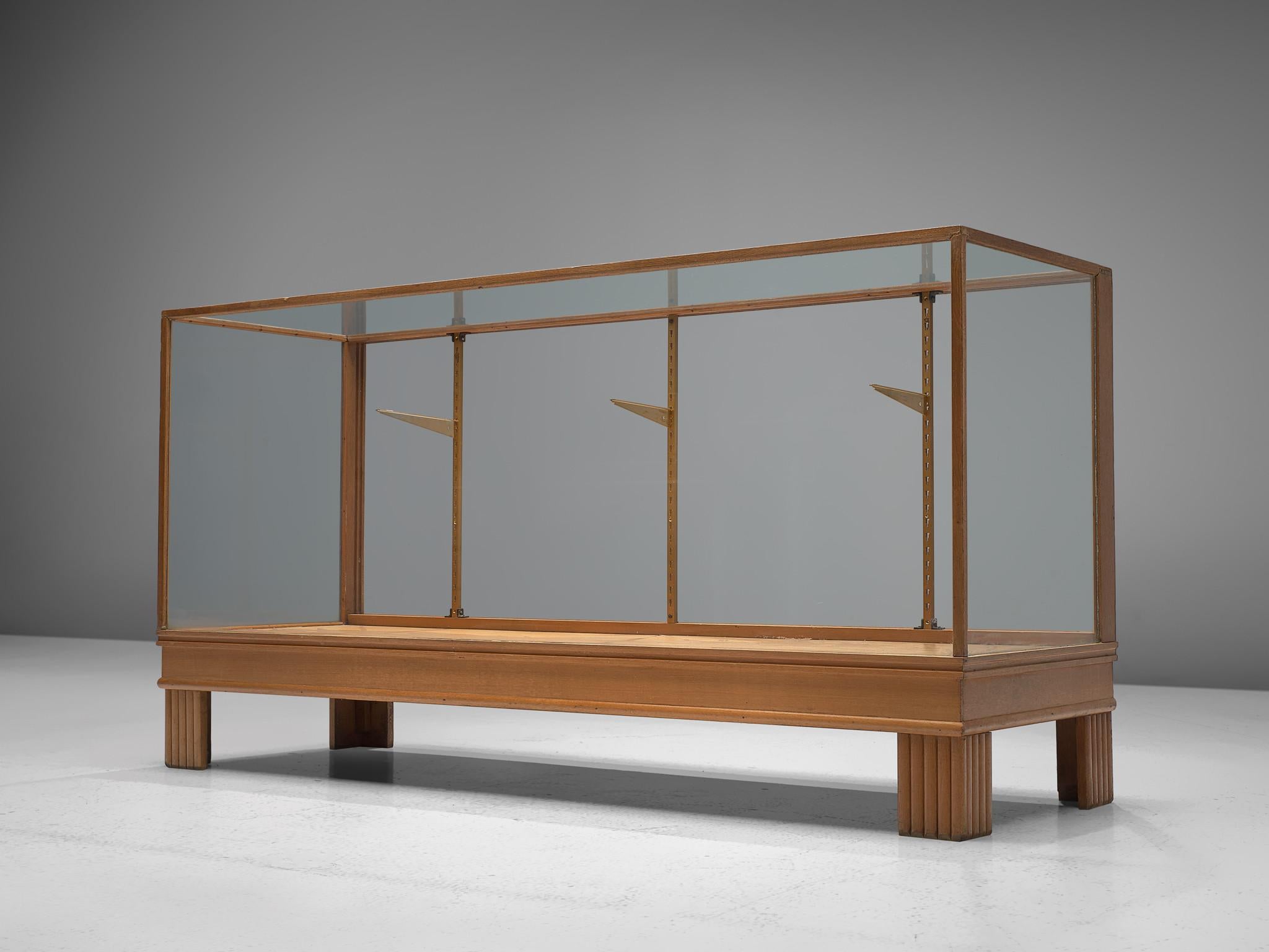 Showcase, oak, glass and brass, France, 1950s.

This large showcase is exactly what you need in the interior of your shop. With five sides covered in glass, the clients will be able to take a good look at your collection. The showcase is finished