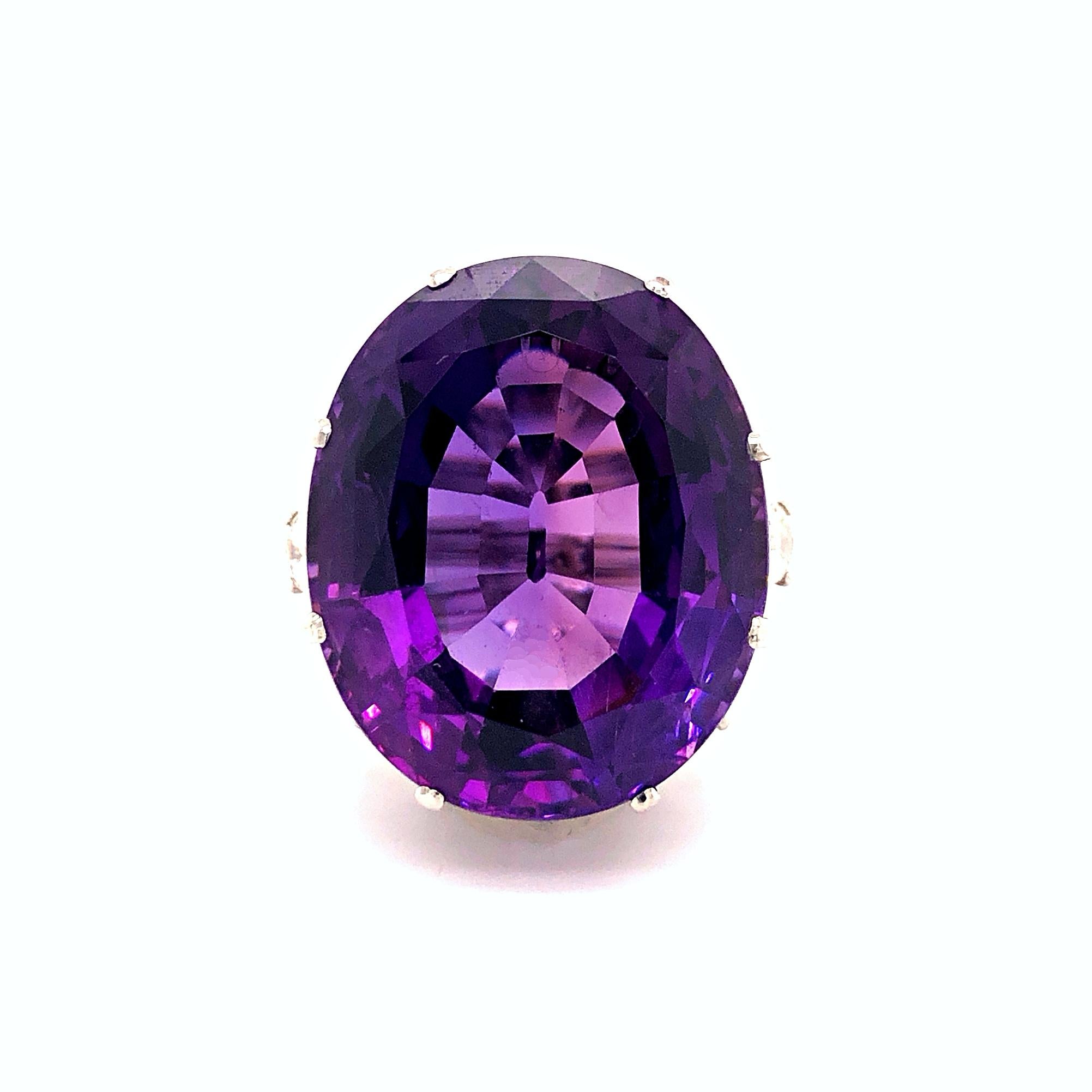A magnificent large amethyst and diamond cocktail ring in 18k white gold. The oval shaped faceted Siberian amethyst is an impressive stone weighing approximately 42 carats. It has no eye visible inclusions, a spectacular crystal and a vivid