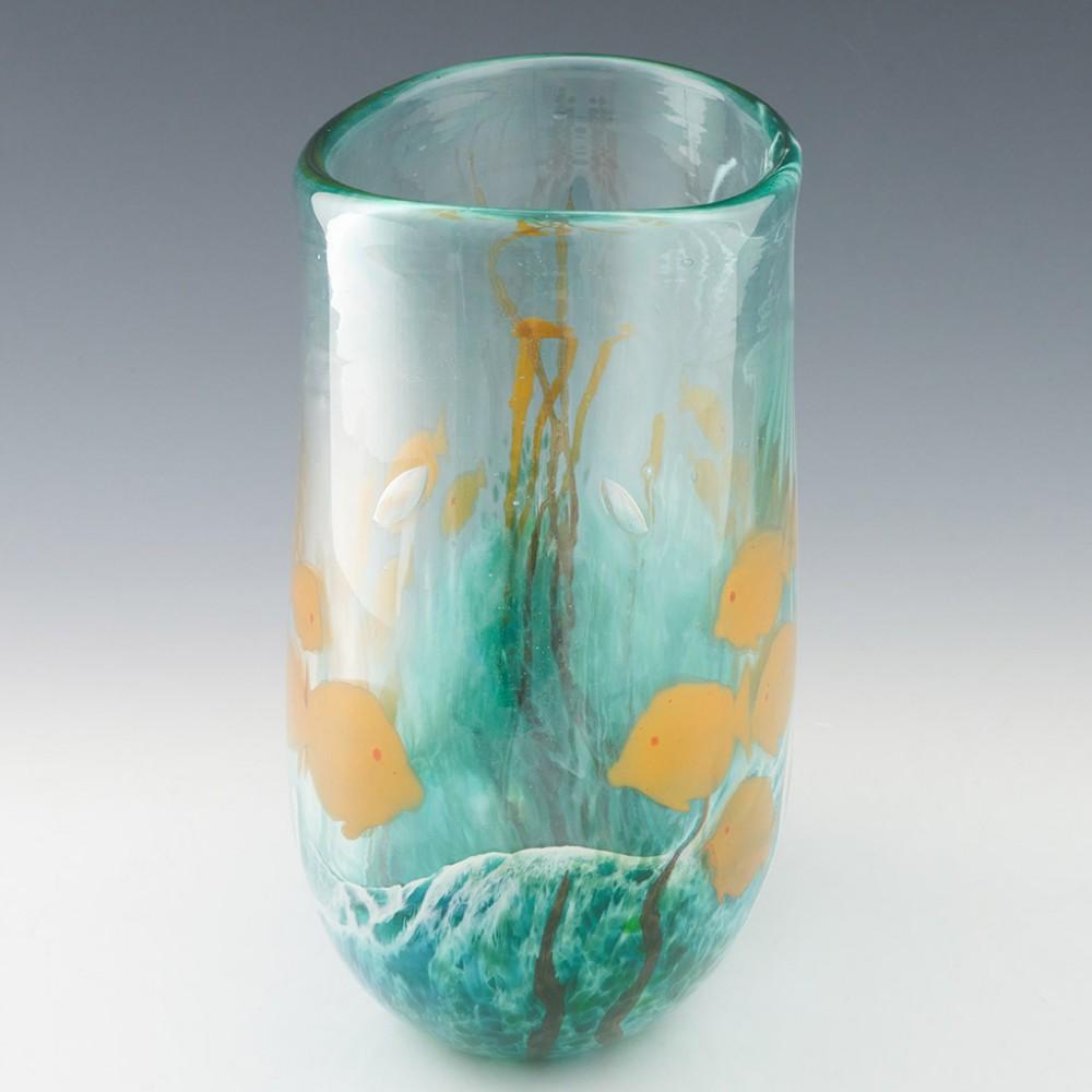 Heading : Large Siddy Langley 'Reef' vase
Date : 2004
Origin :  Devon, England
Bowl Features : Pale blue glass depicting a school of orange fish swimming around coral
Marks : Signed Siddy Langley 2004
Type : Lead
Size : 23cm height, 25cm