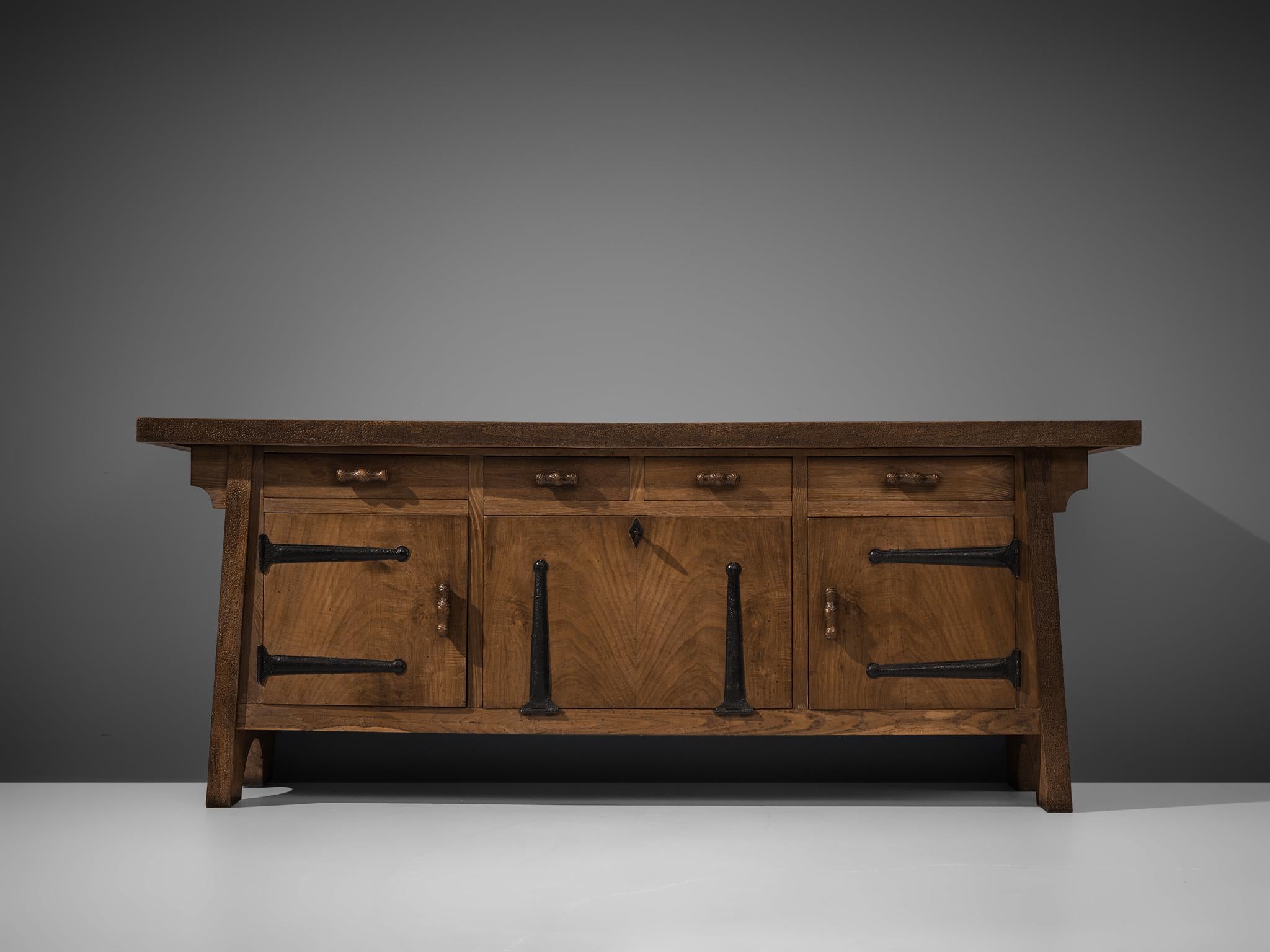 Ernesto Valabrega, large sideboard, oak, iron, Italy, ca. 1935

This large sideboard by Ernesto Valabrega features not only visual qualities but also great storage space. Four drawers and three doors are structuring the outside. The door in the