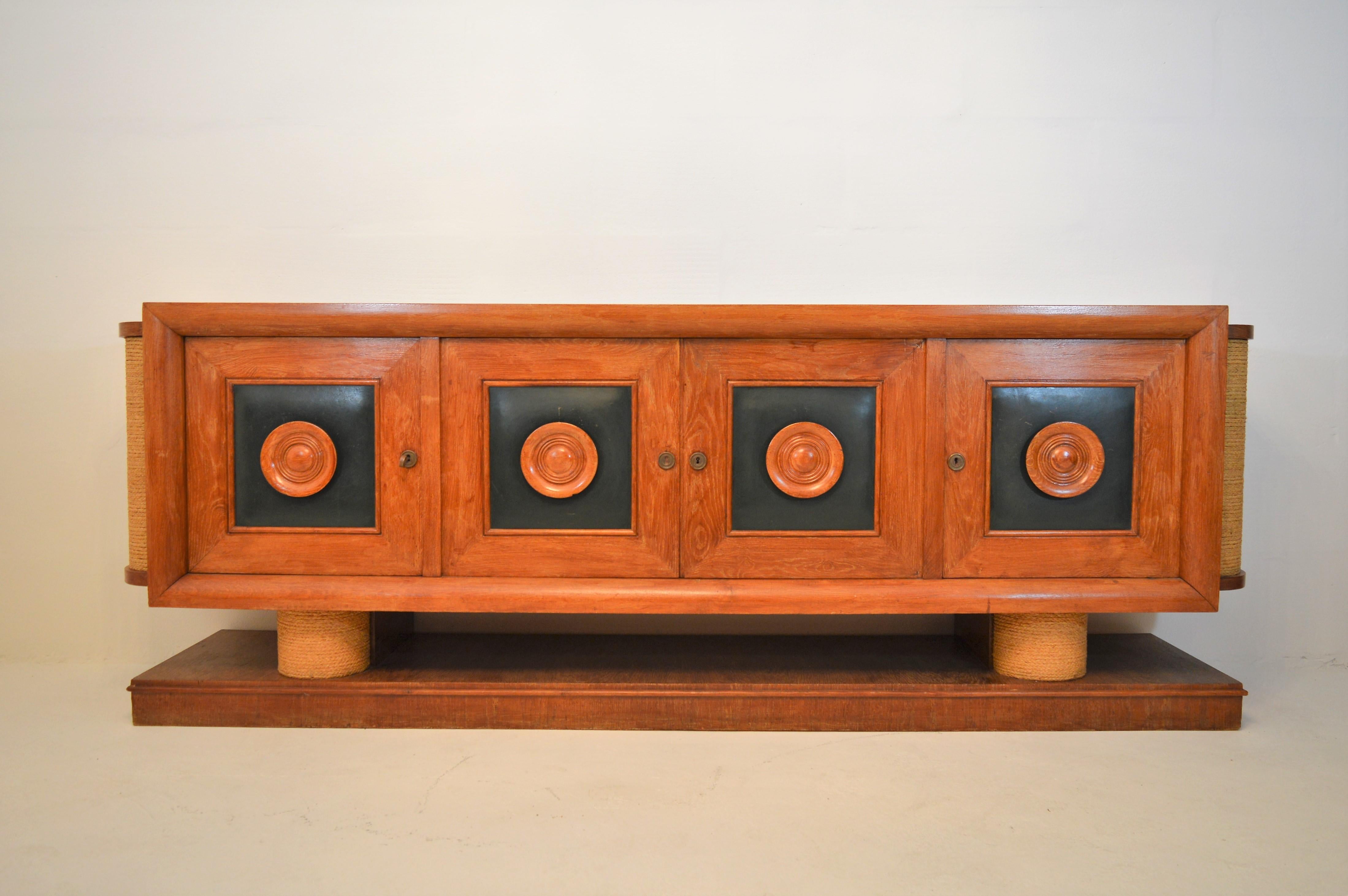 Very exclusive sideboard in oak, green leather and rope, created by the French designers Audoux and Minet in 1940.The sideboard is in a good, but unrestored condition with some minor faults.
 