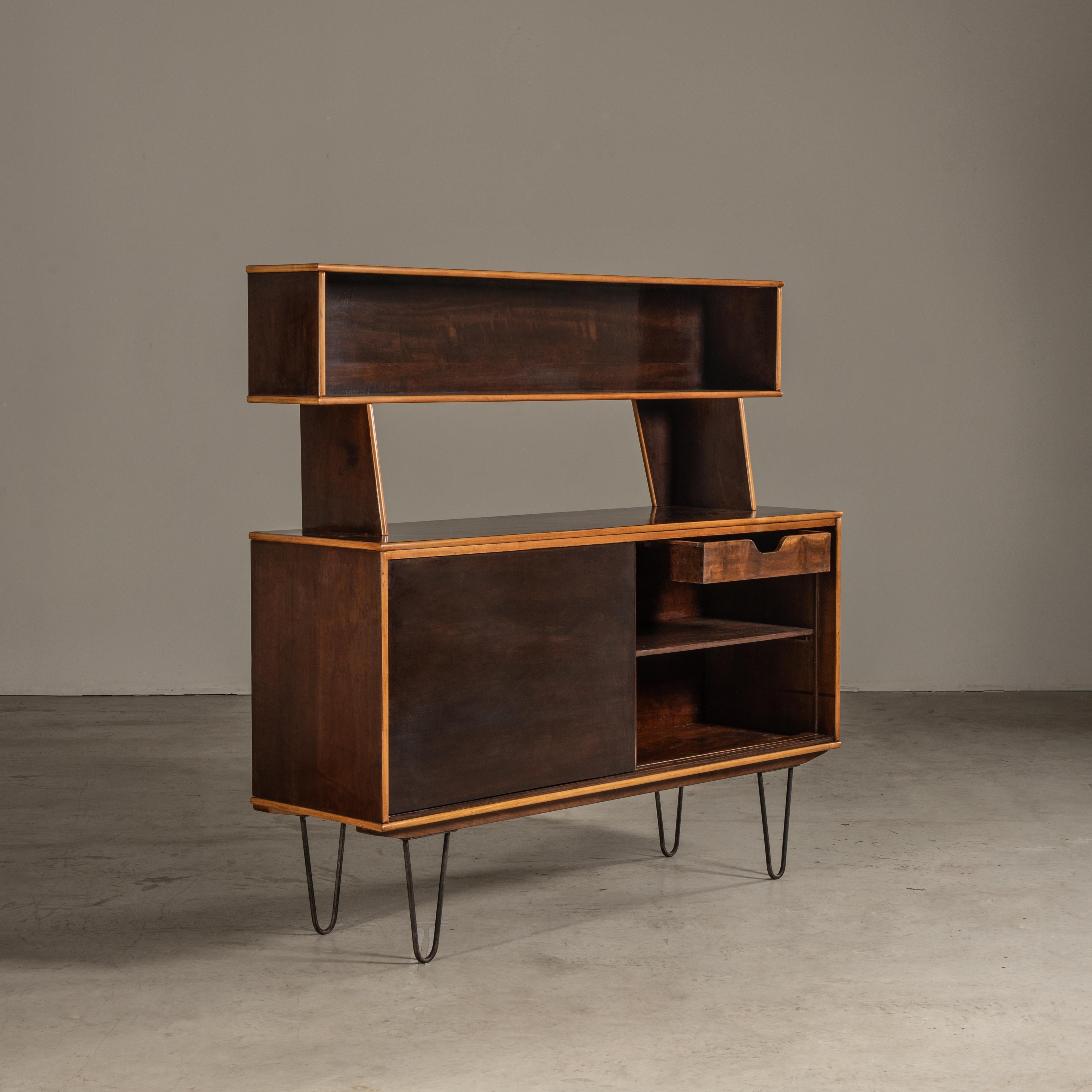 This wooden sideboard was designed by Martin Eisler. Martin Eisler was a key figure in Brazilian furniture design during the mid-20th century, known for his significant contributions to modern design. His work is often associated with a style that