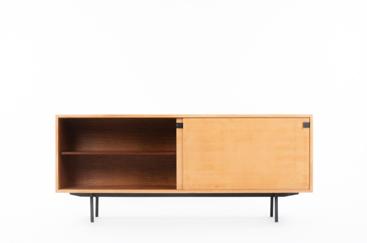 Large sideboard designed by famous french designer Alain Richard, edited by Meuble TV in 1950. 
Label inside, composed of 2 sliding doors in elm. On the left a shelf, on the right two shelves and three drawers. 
Black metal lacquer legs and