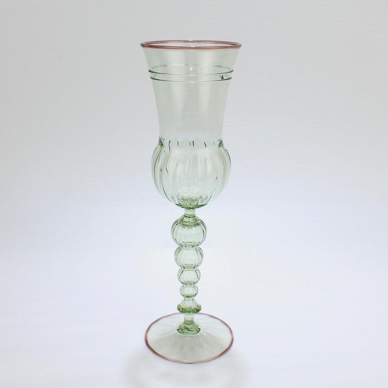 A large Alan Goldfarb Venetian style art glass goblet.

In green glass with a light purple applied lip and footrim. 

Alan Goldfarb was a student of Dale Chihuly and Lina Tagliapetra at Pilchuk. His work is held in numerous private and public
