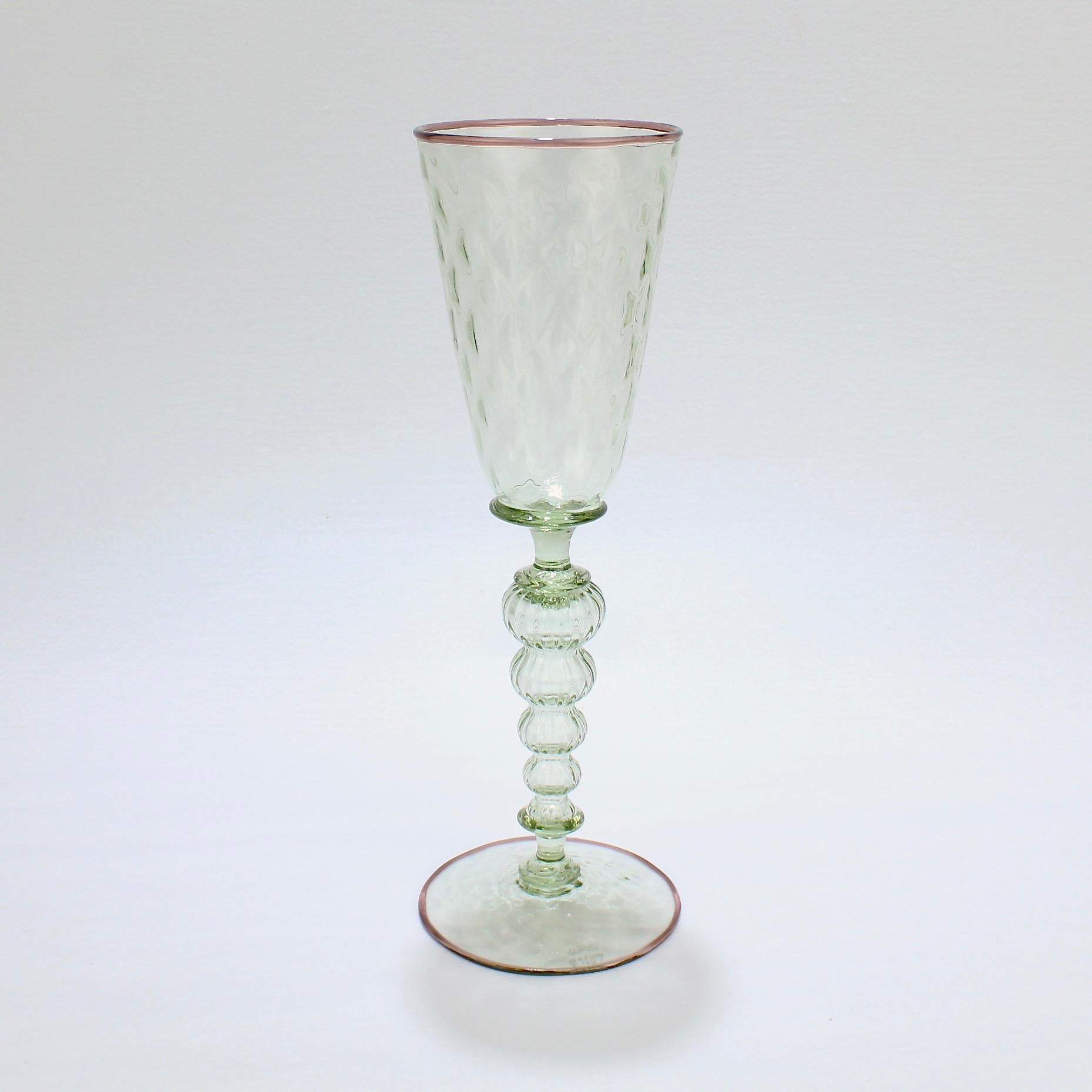 A large Alan Goldfarb Venetian style goblet. 

In green glass with a light purple applied lip and footrim. 

Alan Goldfarb was a student of Dale Chihuly and Lina Tagliapetra at Pilchuk. His work is held in numerous private and public collections,