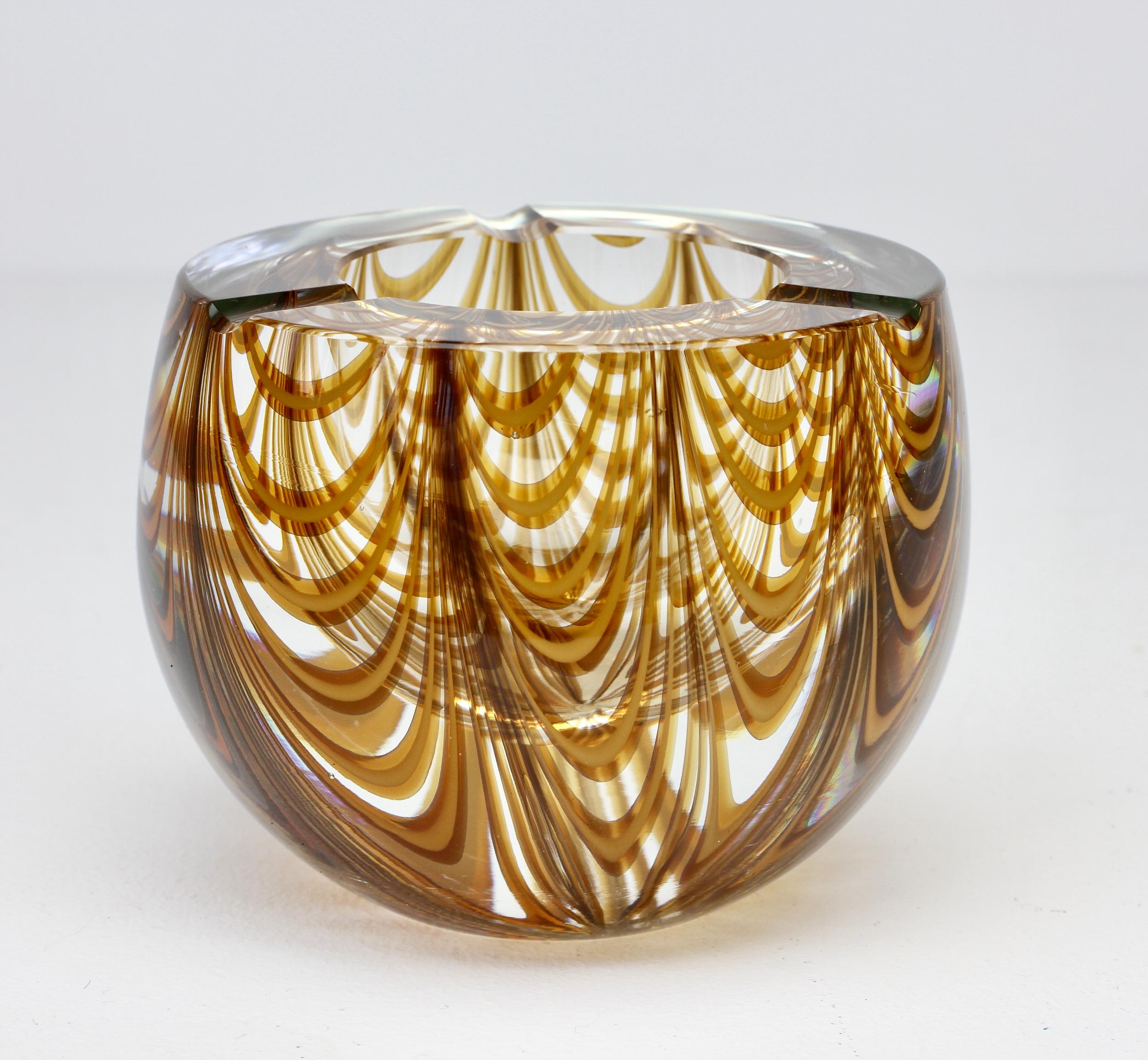 Antonio da Ros (attributed) for Cenedese large and heavy vintage Mid-Century Modern Italian Murano glass ashtray, circa 1965-1975. This large, heavy piece of glass features an asymmetric design of amber toned glass curved 'Zebrato' stripes encased