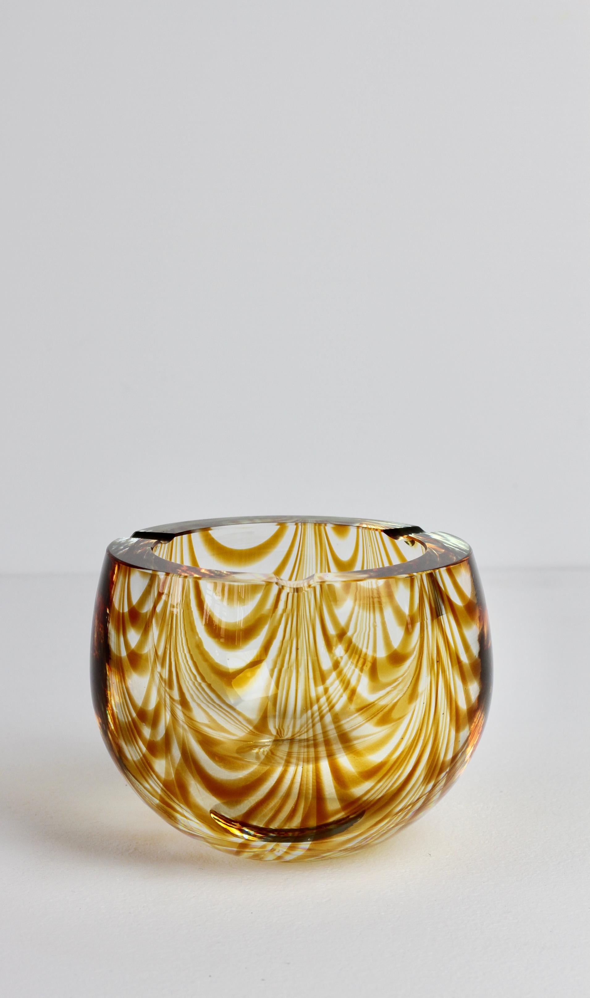 Antonio da Ros (attributed) for Cenedese large and heavy vintage Mid-Century Modern Italian Murano glass ashtray, circa 1965-1975. This large, heavy piece of glass features an asymmetric design of amber toned glass curved 'Zebrato' stripes encased