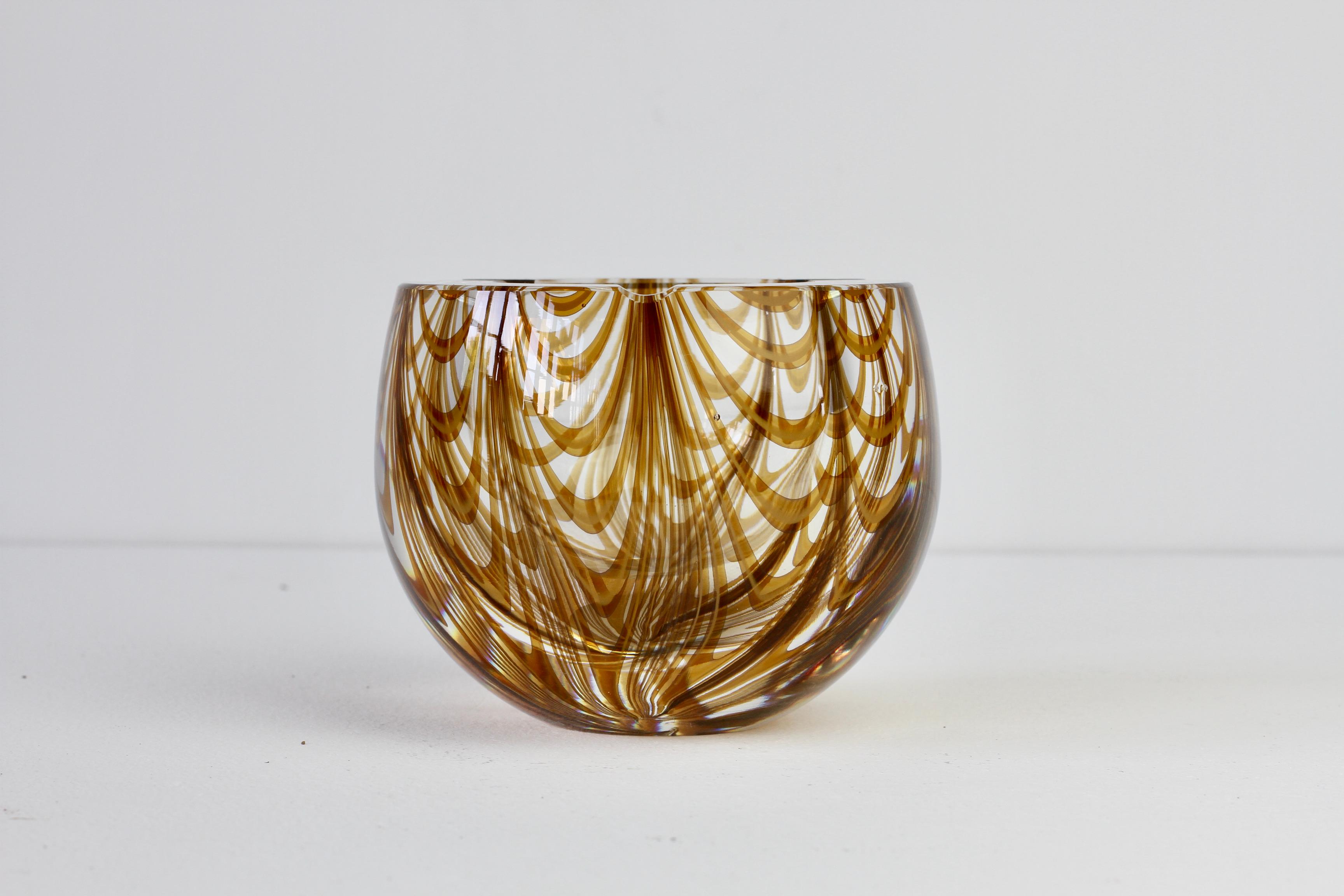 Antonio da Ros (attributed) for Cenedese large and heavy vintage Mid-Century Modern Italian Murano glass ashtray, circa 1965-1975. This large, heavy piece of glass features an asymmetric design of amber toned glass curved 'Zebrato' stripes encased