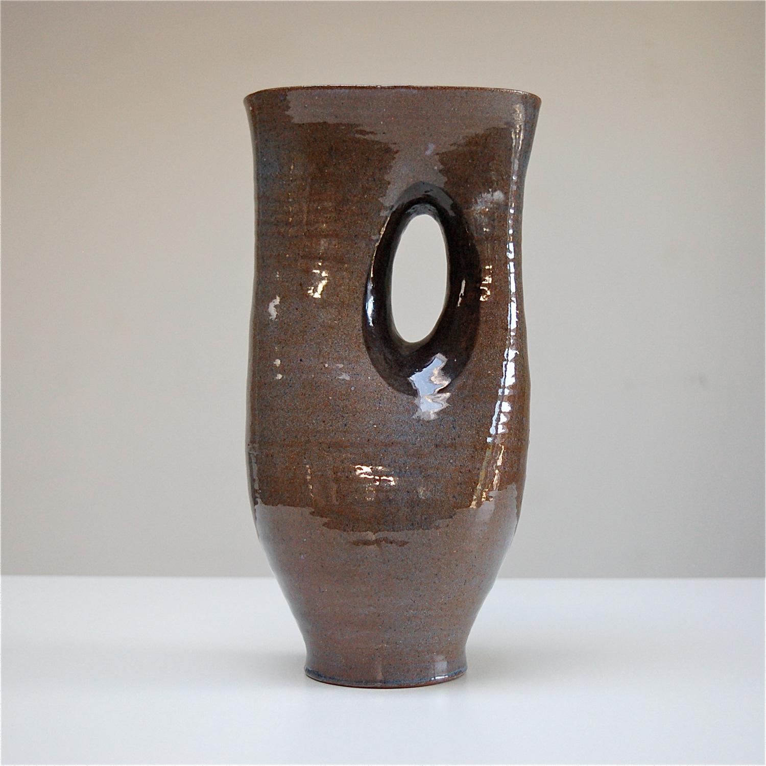 This exceptional glazed ceramic vase is an early work by Antoine de Vinck. The soft, fluid shape is very complex and could only have been made by a gifted ceramicist like de Vinck. The glaze consists of different shades of brown, grey and blue and
