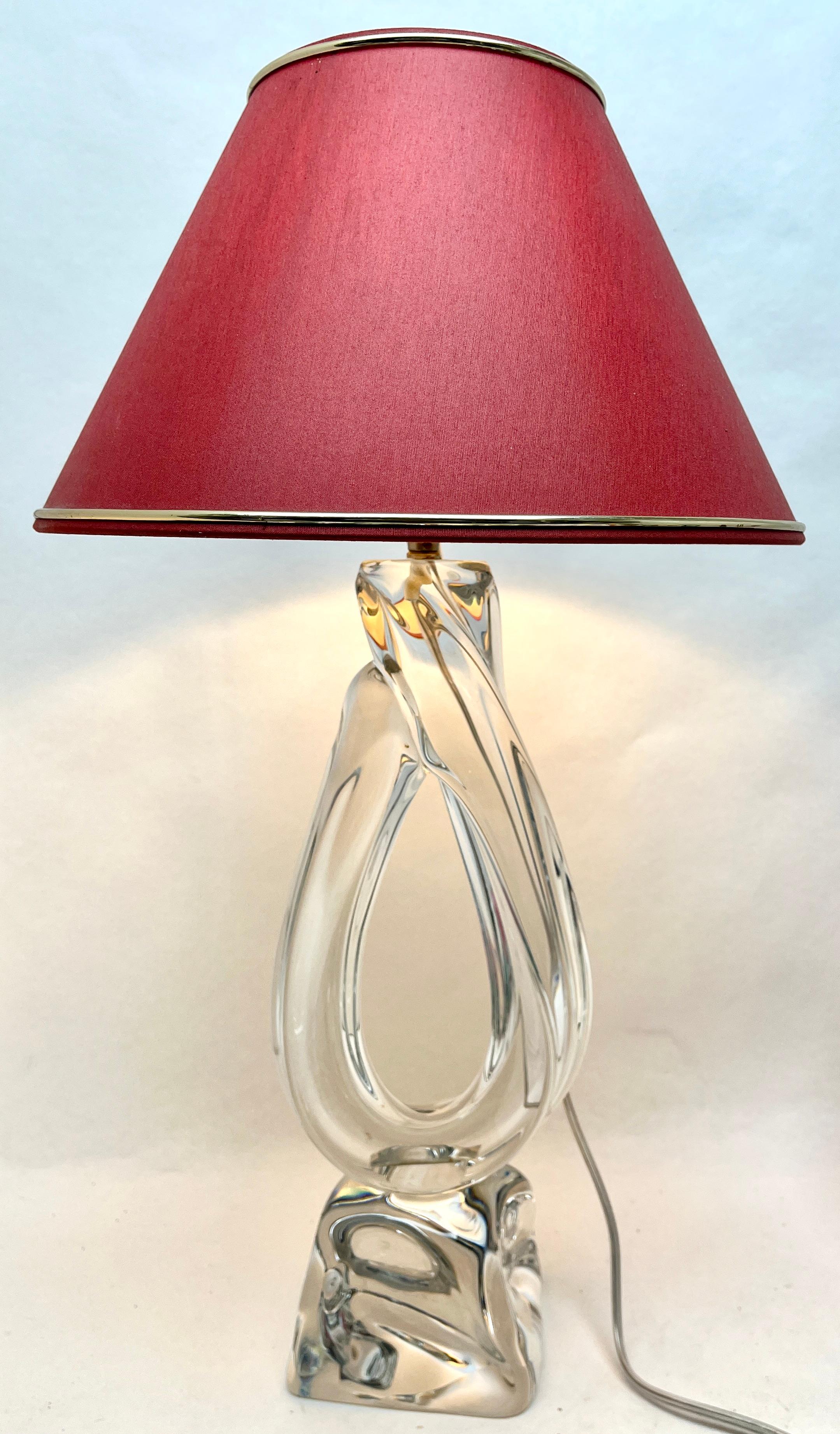 This simple yet dramatic table lamp is in large size; 15.74 inches excluding the lamp-fitting and shade. The claer core in classic Daum has been given a thick sommerso (clear crystal casing) so that the object appears delicate whilst remaining solid