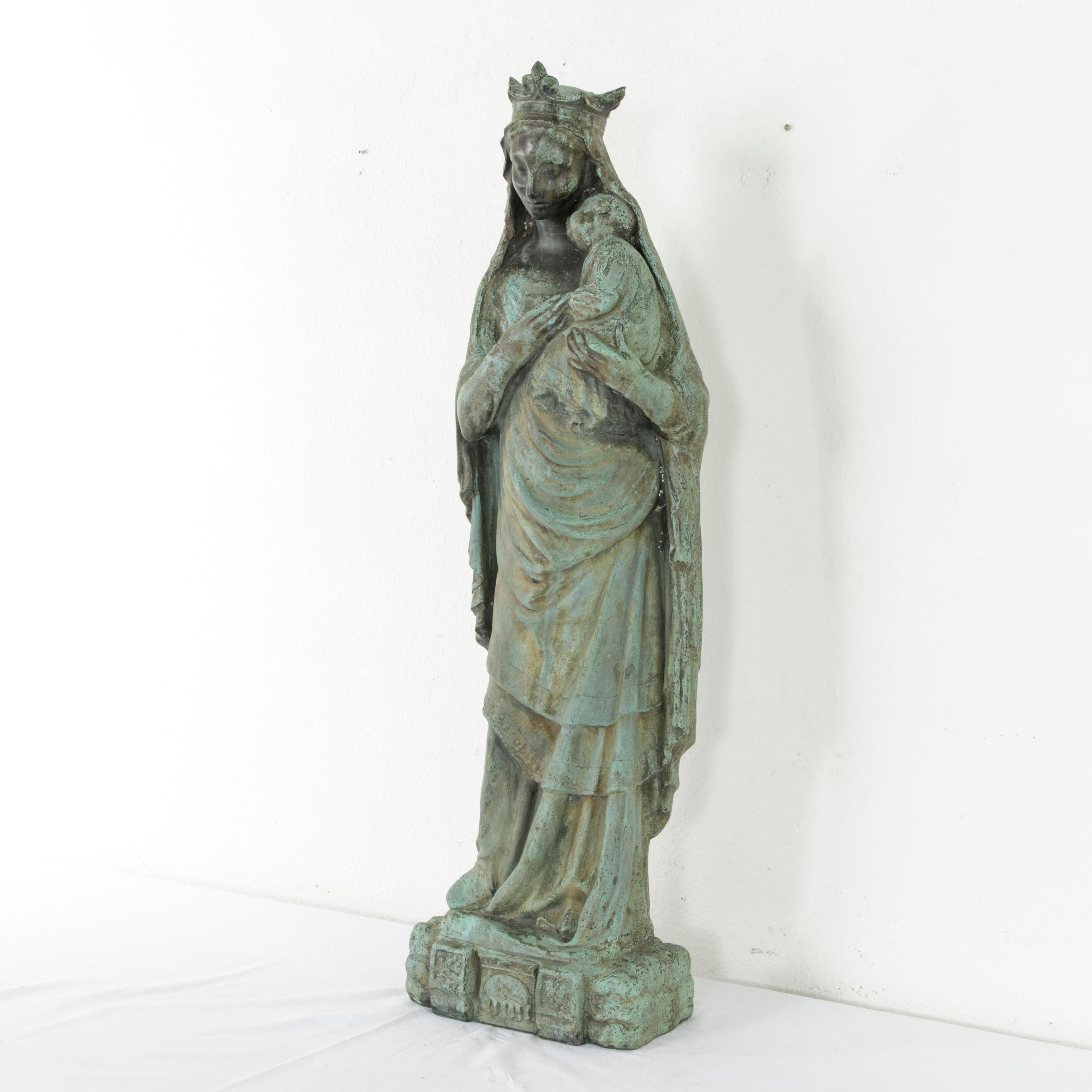 Standing at an impressive 41 inches in height, this large bronze statue or sculpture of the Madonna and Child was originally in the courtyard of a convent in the region of Normandy, France. Signed by the artist Marcel Declerck and dated 1922, this