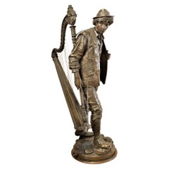 Large Signed Eutrope Bouret Bronze Sculpture of a Young Man Carrying a Harp