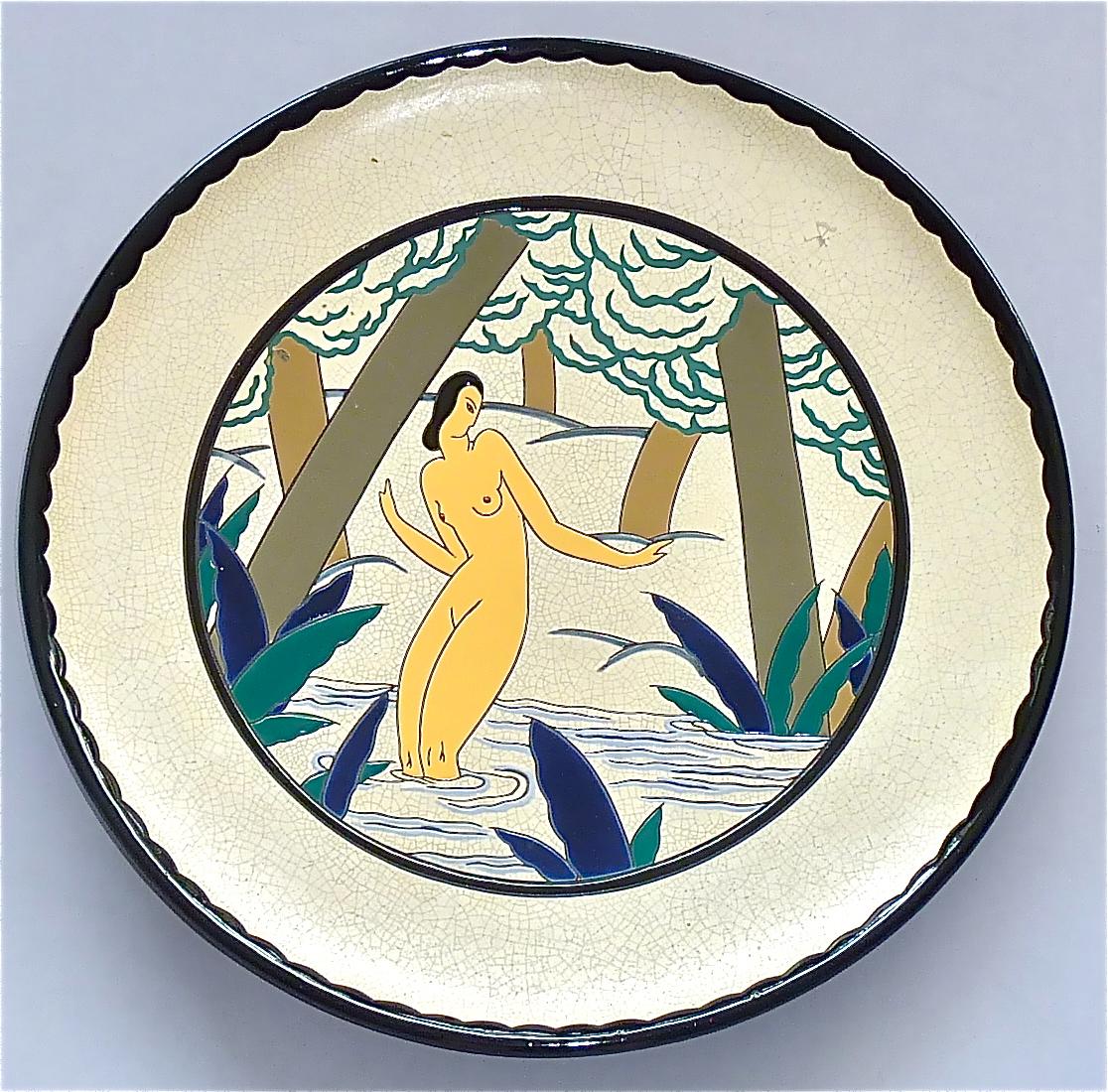 Large amazing Art Deco plate showing a bathing black haired nude in an elegant and typical Art Deco pose. The hand-crafted art ceramic or pottery plate which is made for wall hanging too, has a black rim and frame on a faint ivory color crackled and