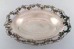 Large silver bowl pierced with grape vines.