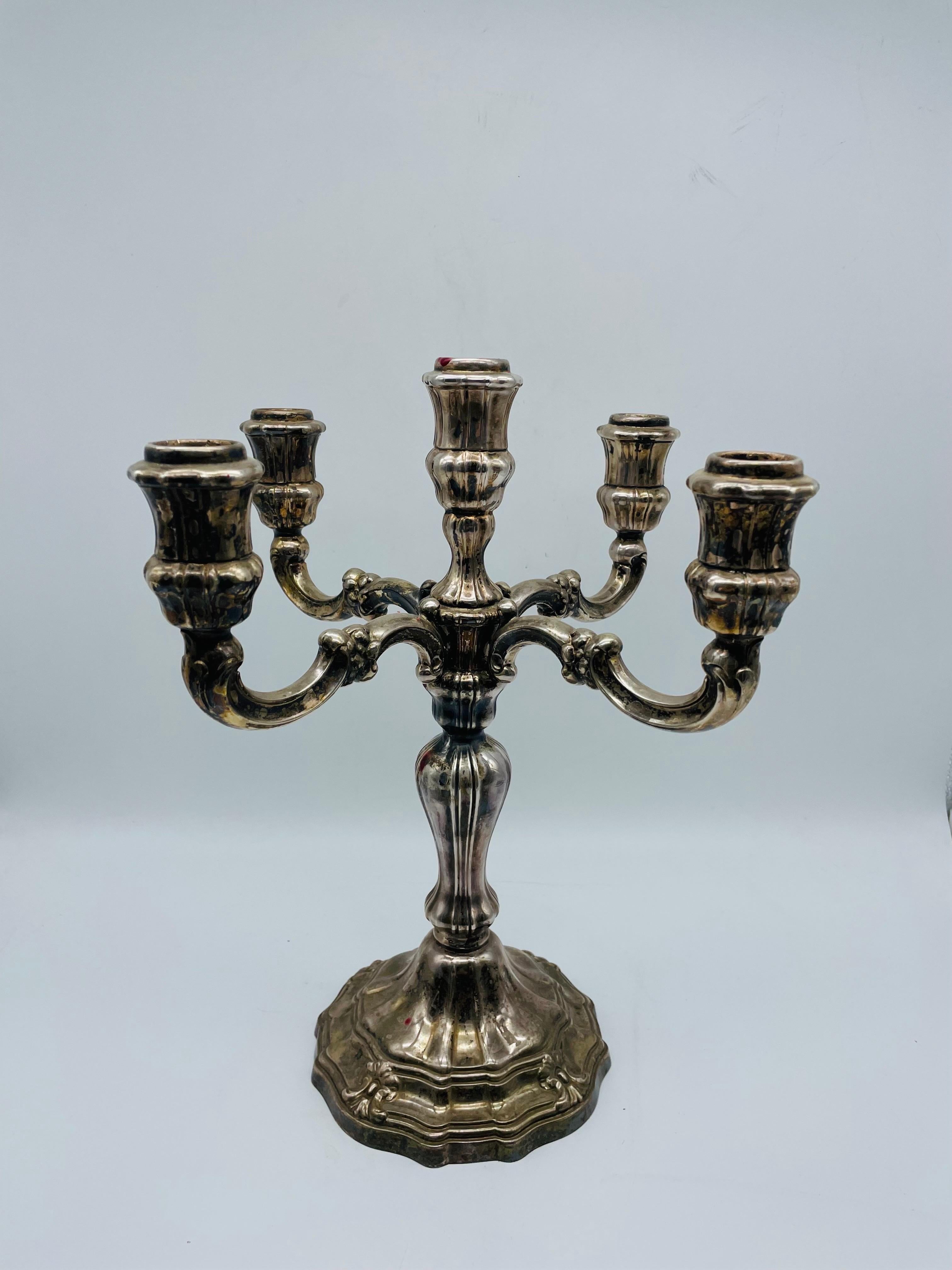 Large candlestick 925 sterling silver.

Multi-profiled candlestick made of 925 sterling silver with crescent moon and crown hallmark with 5 candle arms.