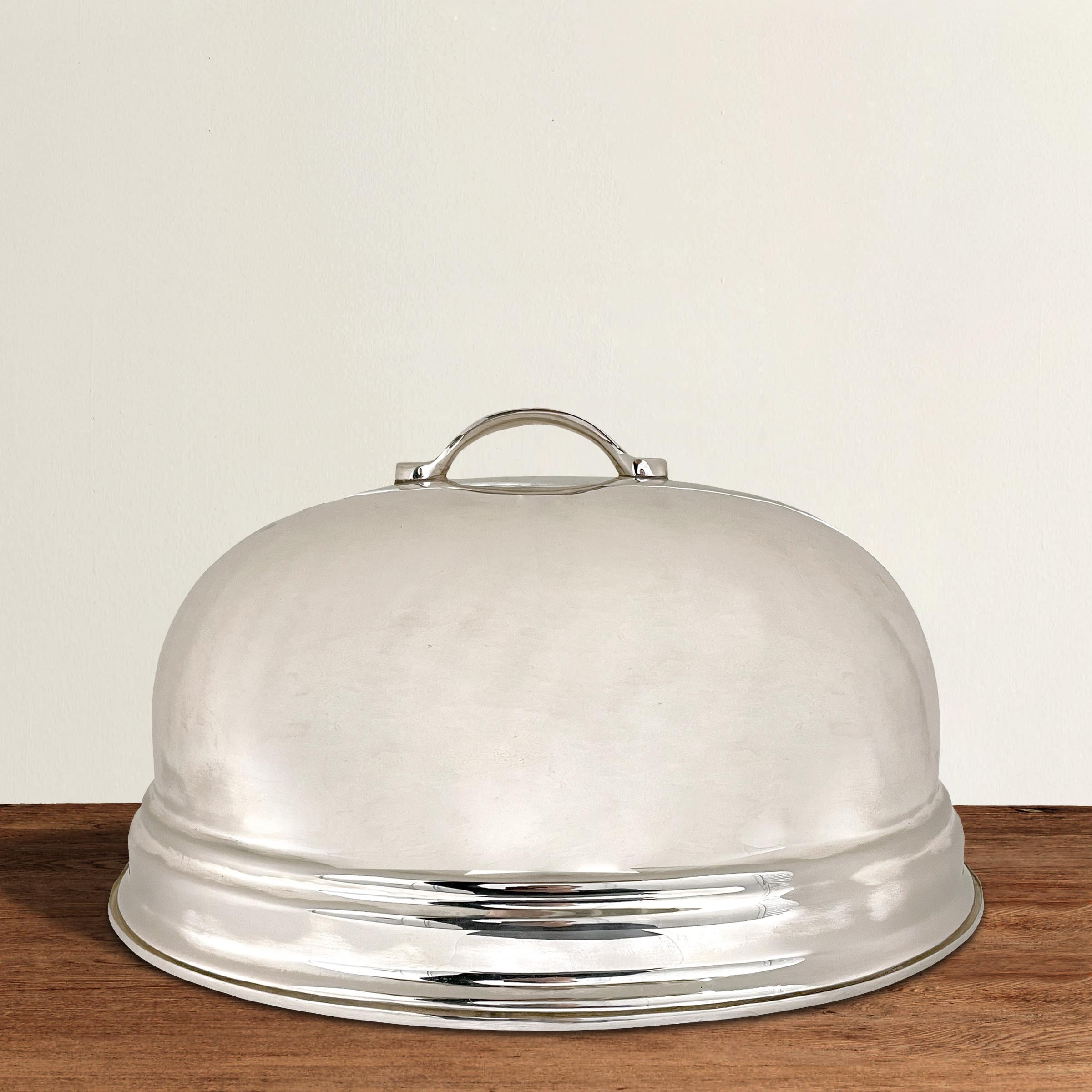 An incredible large silver-plate food dome with a beautiful, simple decorative edge detail. Large enough to fit your Thanksgiving turkey, holiday ham, or a few roast chickens on any other day of the year.