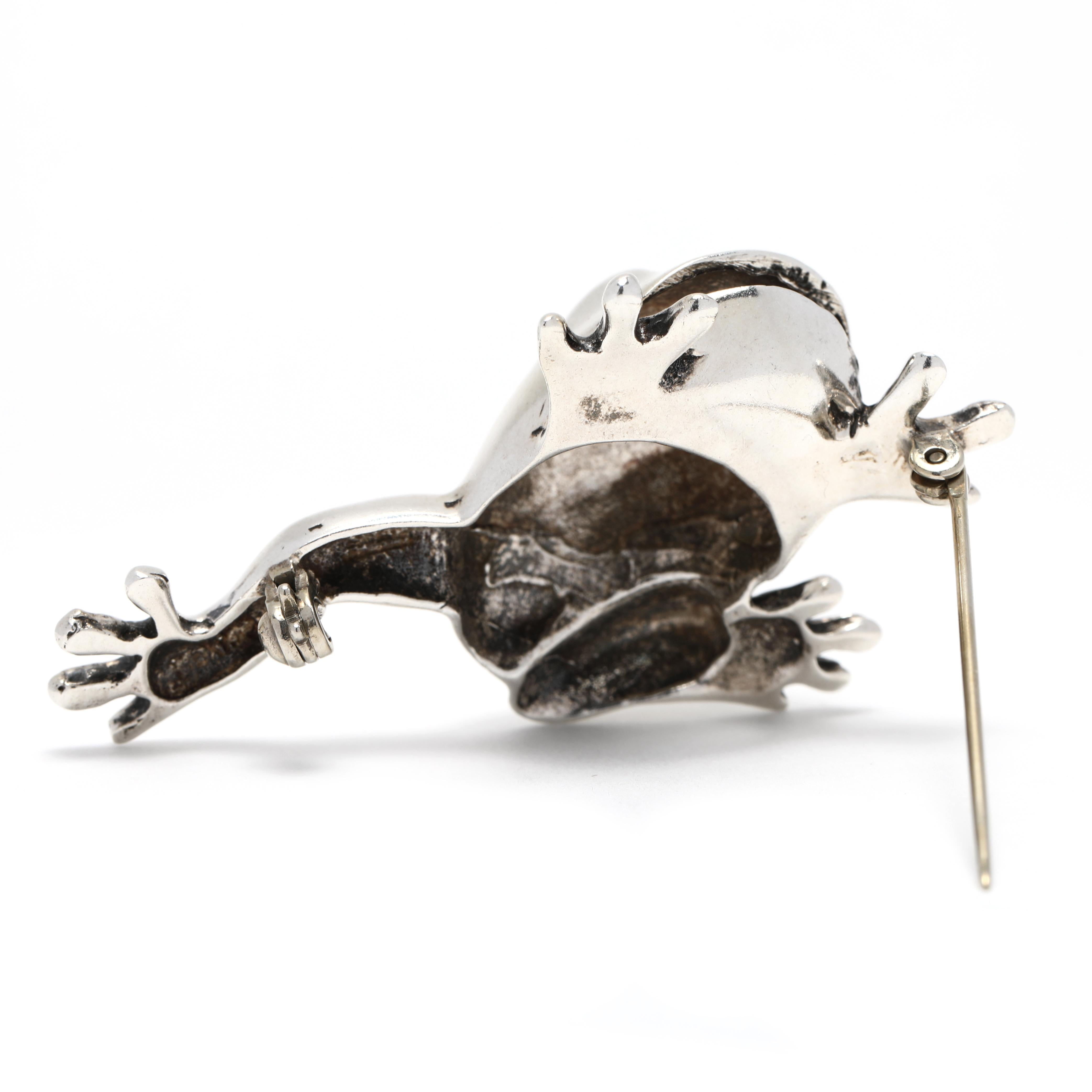 This unique and eye-catching Large Silver Frog Brooch is the perfect way to add a touch of nature to your wardrobe. Crafted from sterling silver, this life size Tree Frog Brooch measures 2 1/8 inches in length for a simple yet eye-catching look.