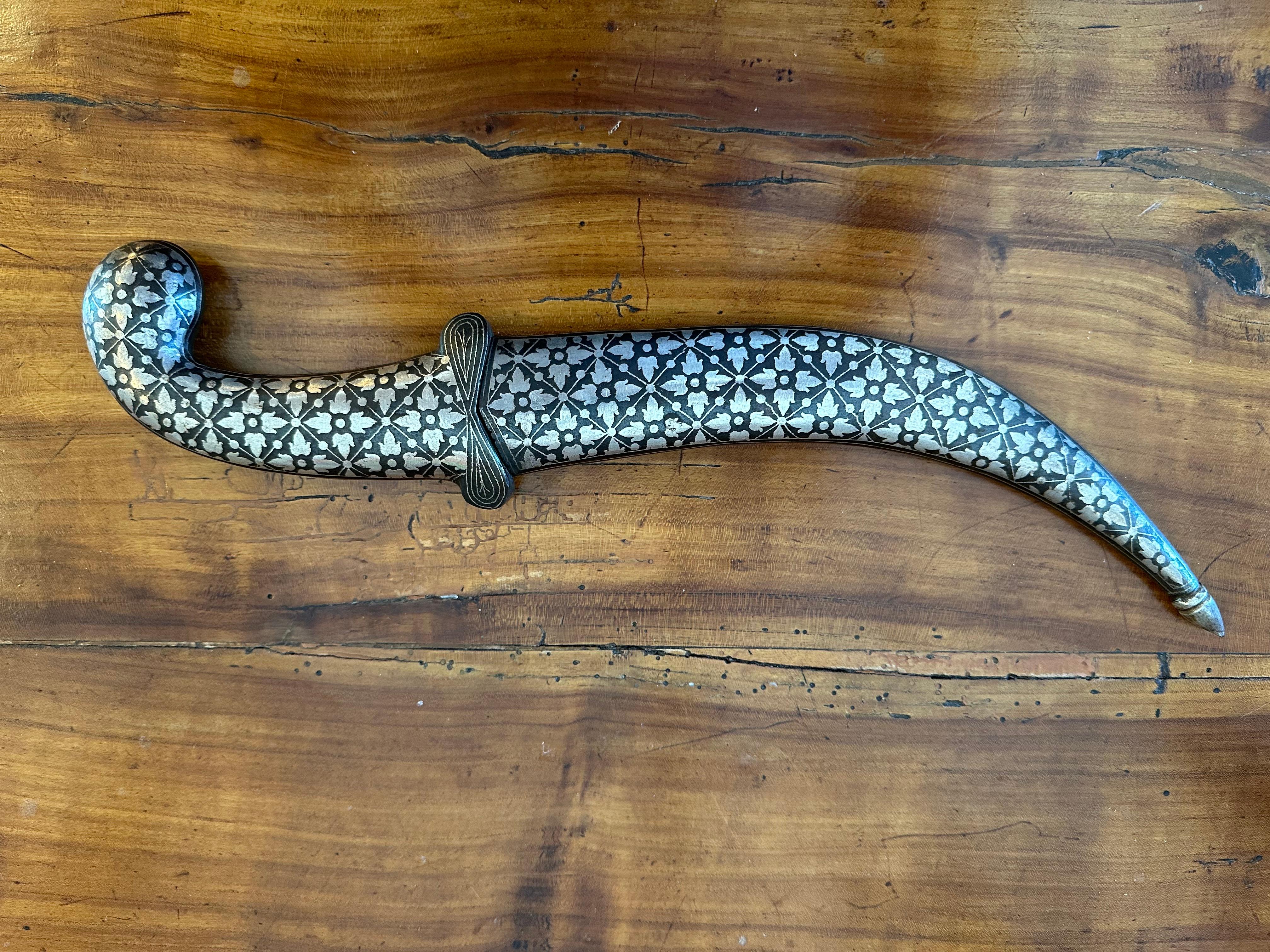 Large Silver “Jambiya” or Curved Dagger With Its Sheath. These are often Extremely well Crafted with Extraordinary inlaid Silver Designs accentuated with “Neillo”.  This Inlaid Handle is unusually fine. These  were worn to Emphasize a Man’s Status.