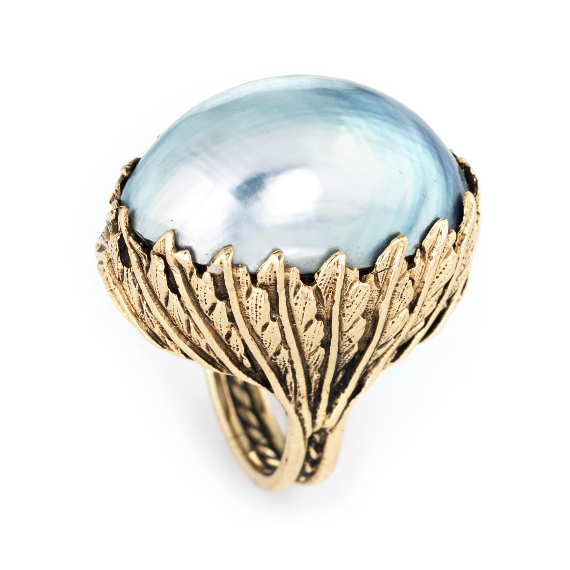 Stylish vintage large mabe pearl ring (circa 1960s to 1970s) crafted in 14 karat yellow gold. 

Large mabe pearl measures 25mm x 15mm. The pearl exhibits a silver to light blue color with good luster. The pearl is in excellent condition and free of