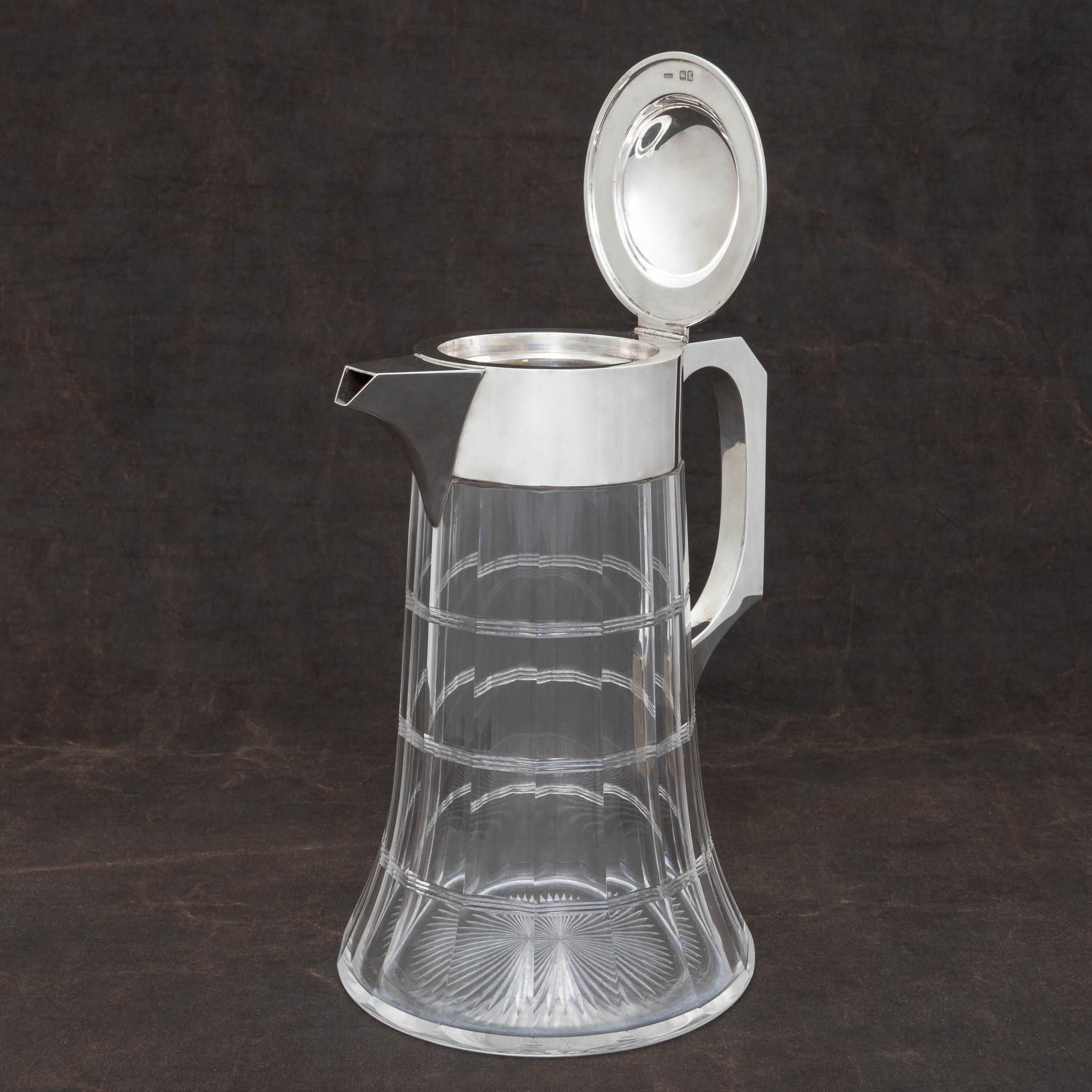 Substantial silver mounted jug with decoration cut in to the glass body and star cut to the base. Made by silversmiths John Grinsell and Sons and hallmarked Birmingham 1901.

Dimensions: 29 cm/11? inches (max. height) x 16.75 cm/6? inches (base